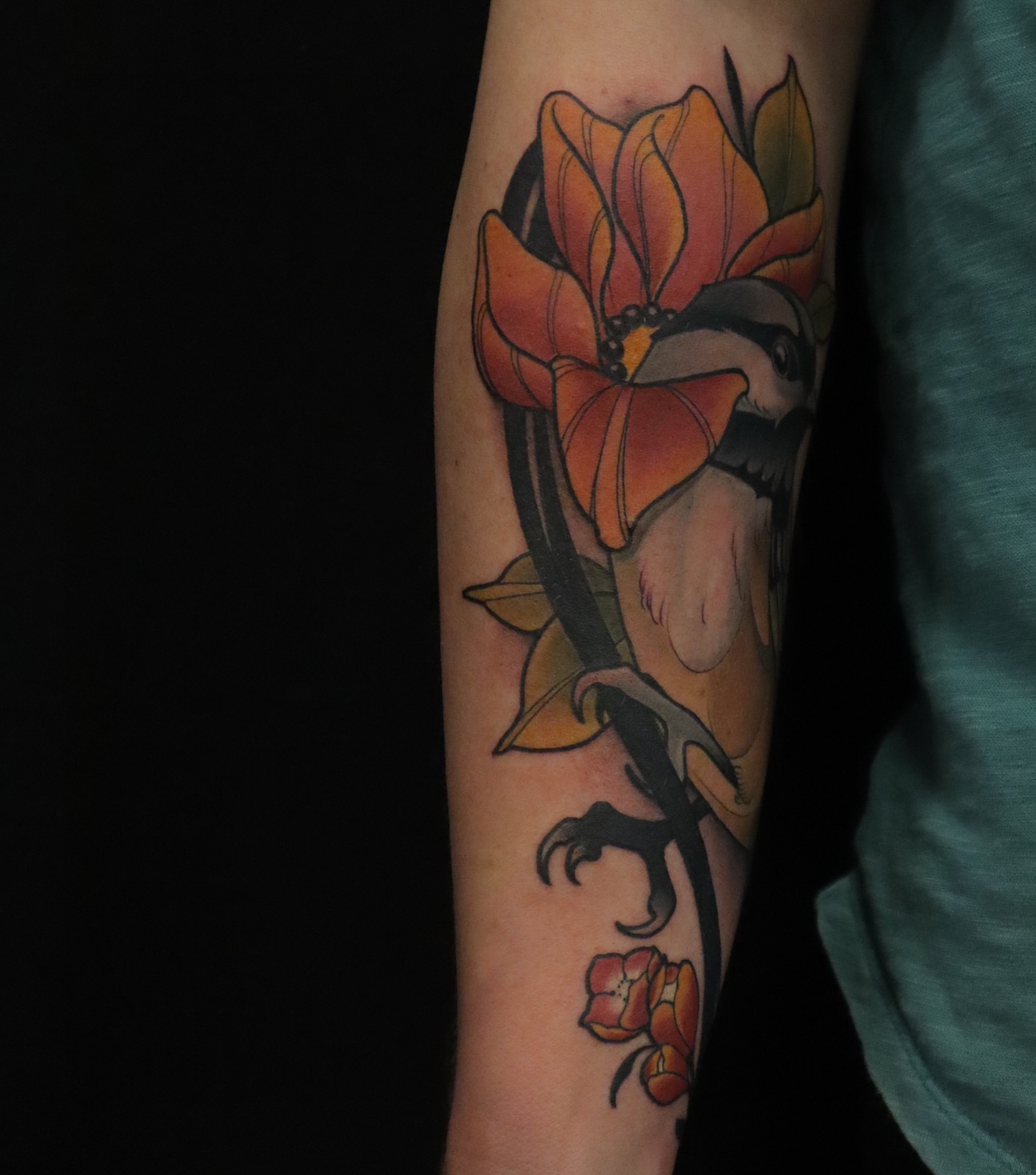 Flower and bird American traditional tattoo on the forearm by Joshua Weeks