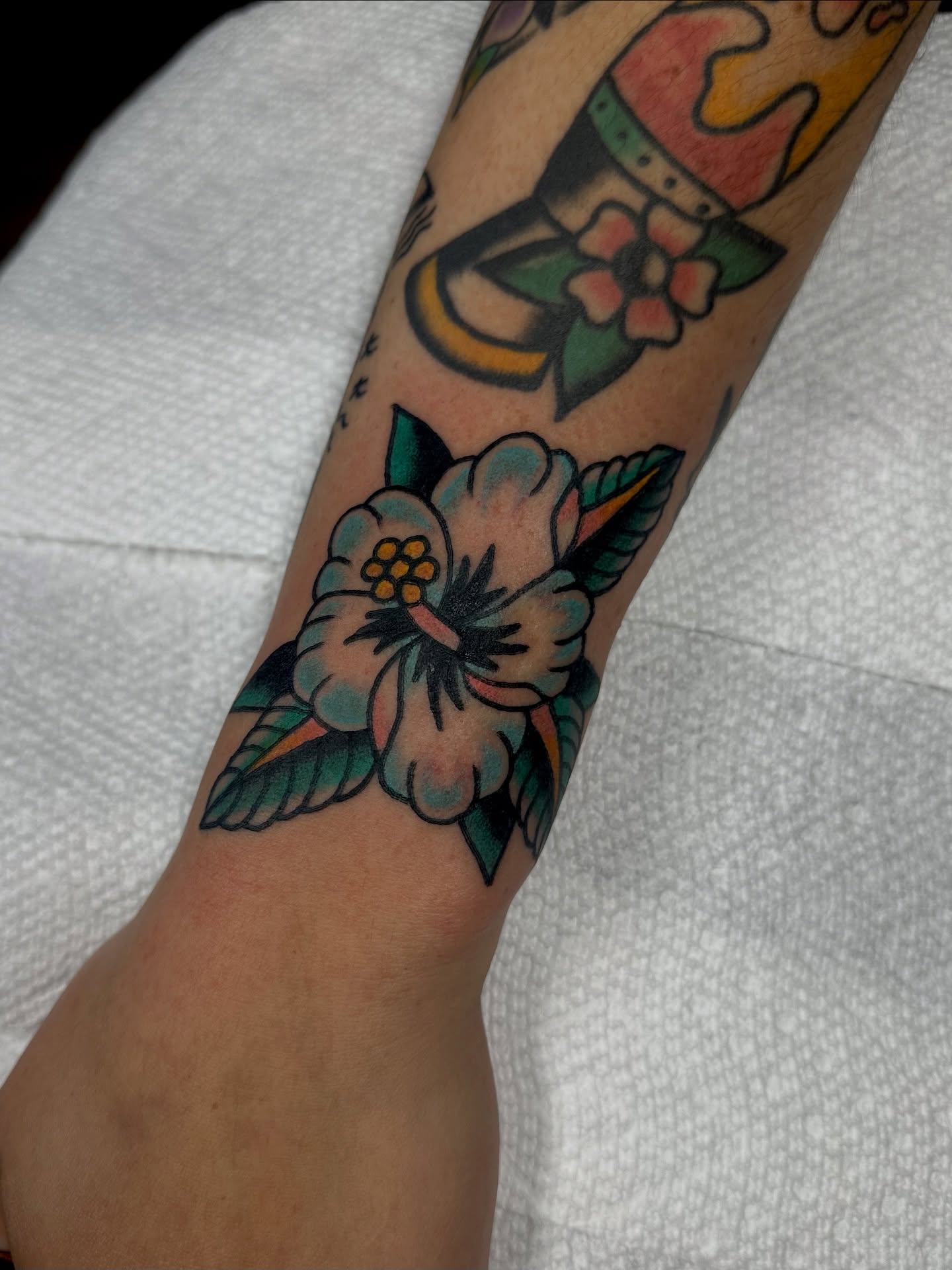 Flower American traditional tattoo on the forearm by Steven