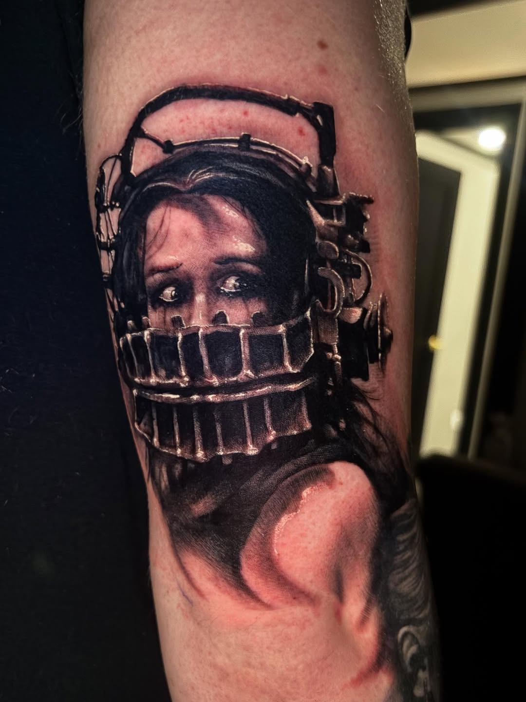 Woman in bear trap helmet realism tattoo on the forearm by Eddie Wolfe