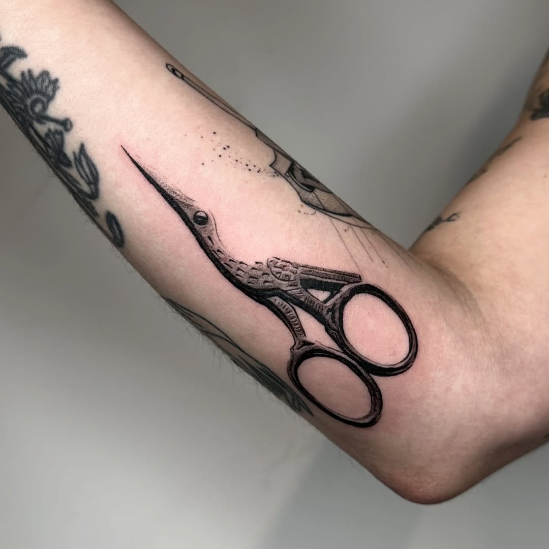 Embroidery scissors dotwork tattoo on the forearm by reid - tattoo artist
