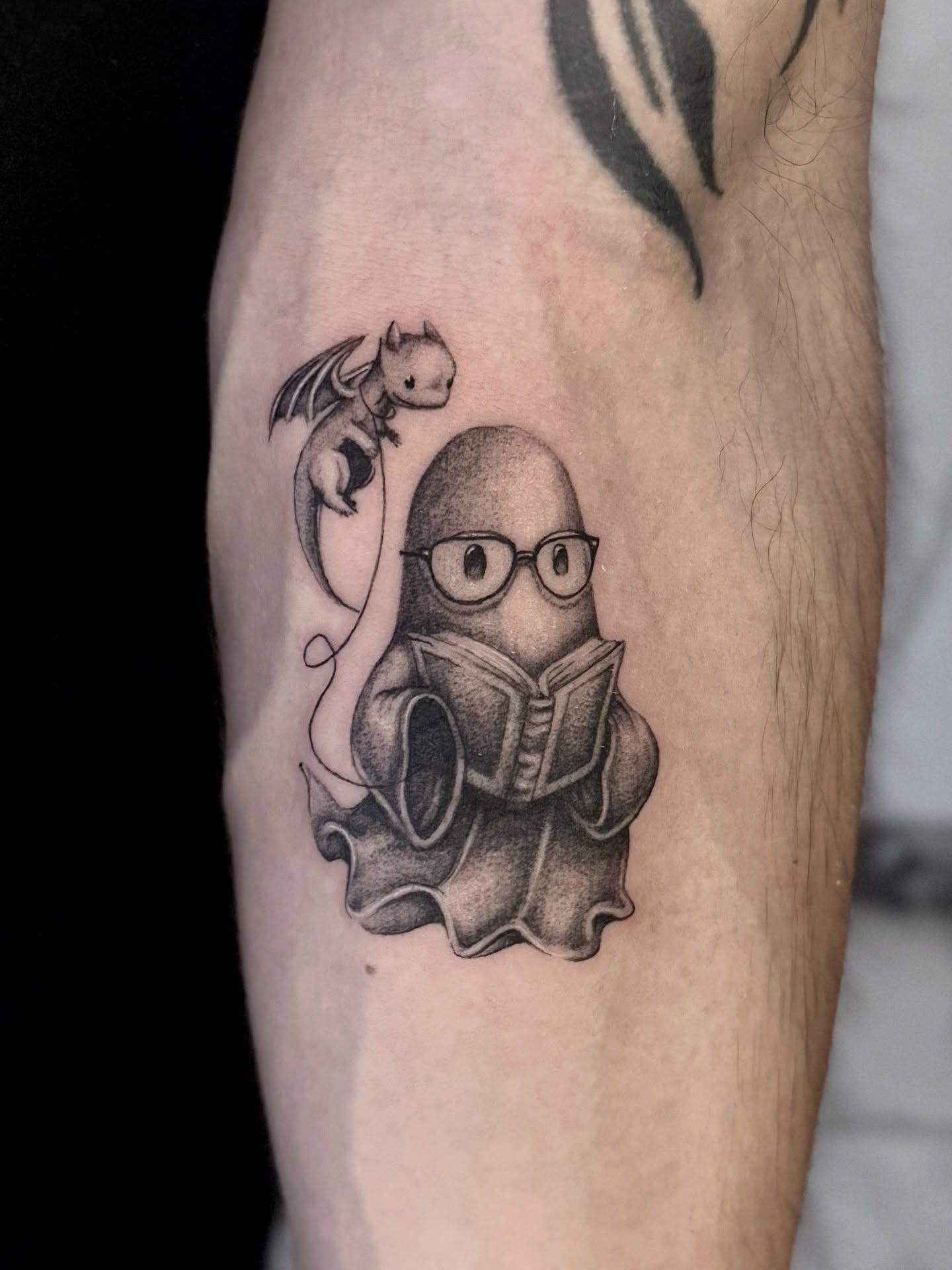 Octopus reading book dotwork tattoo on the forearm by Miro Ink Tattoo