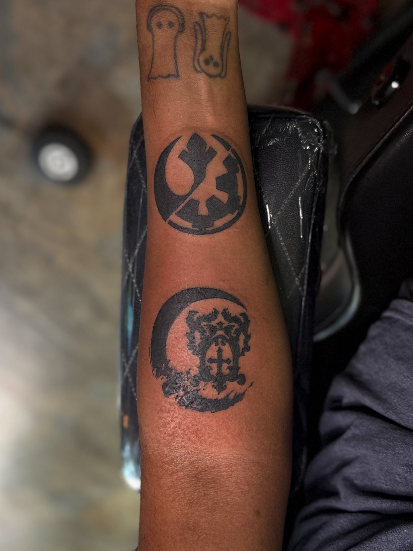 Rebel alliance symbol black and grey tattoo on the forearm by Yohana Vargas