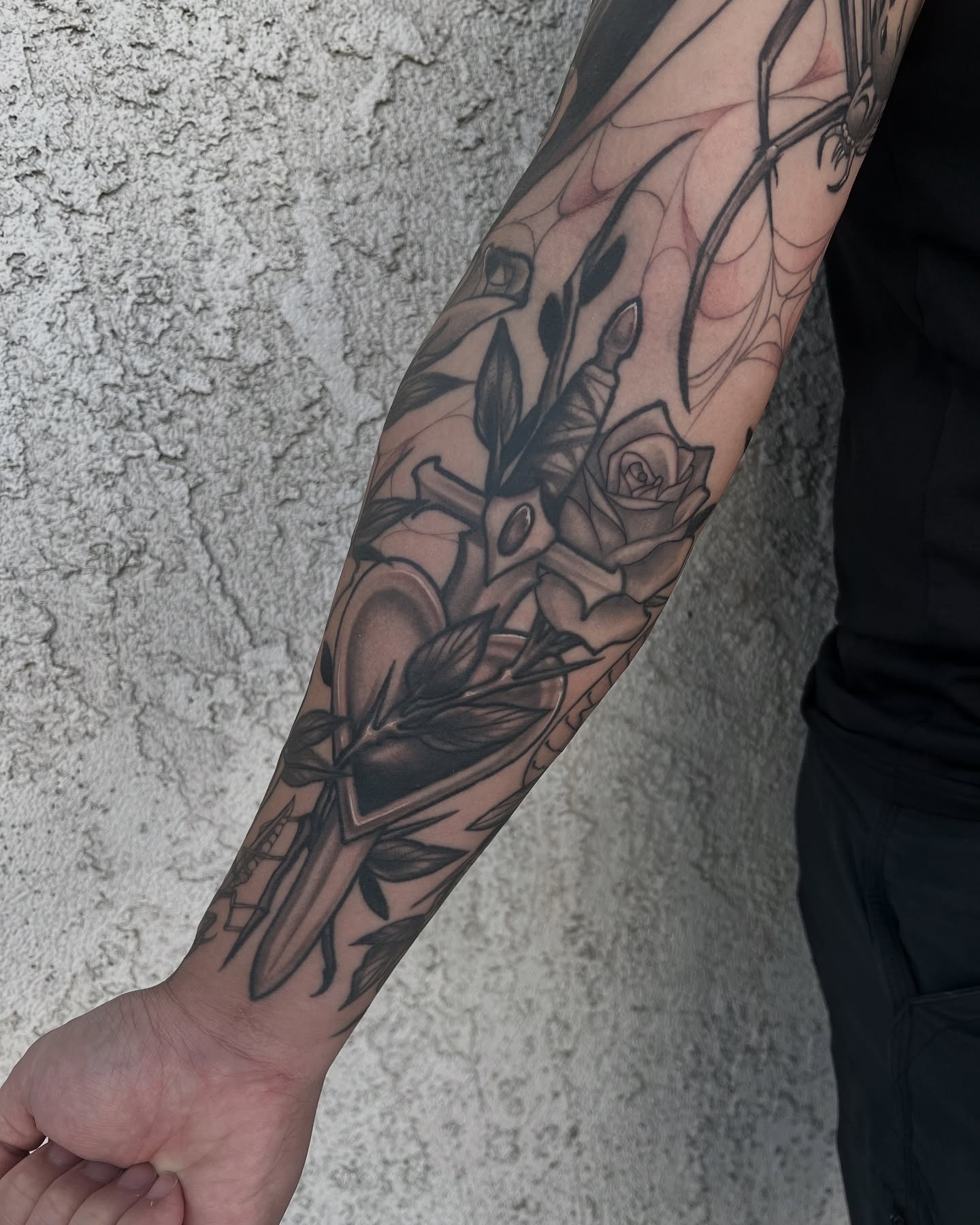 Rose and arrow black and grey tattoo on the forearm by Las Vegas Tattoo Artist