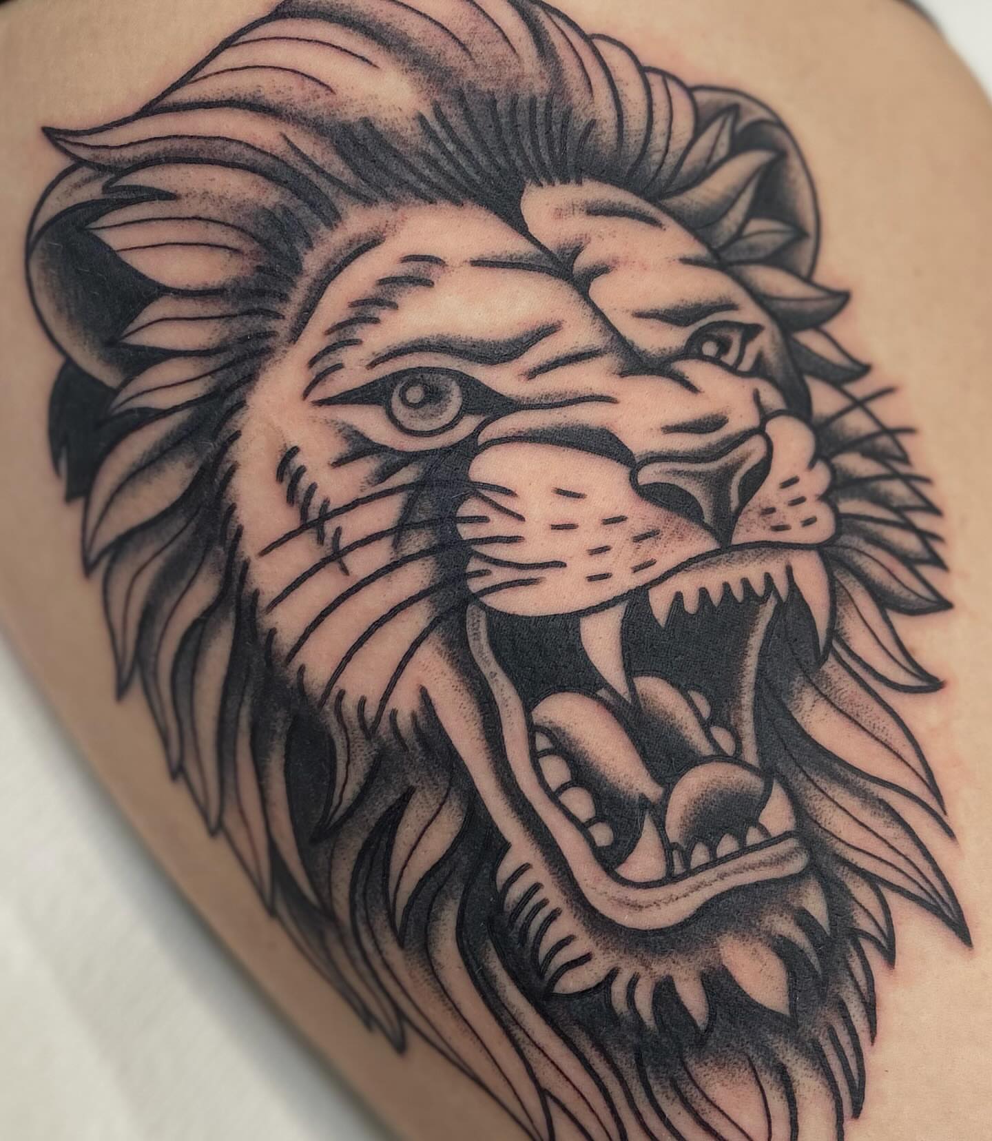 Lion black and grey tattoo on the thigh by Kiera ❤️‍🔥