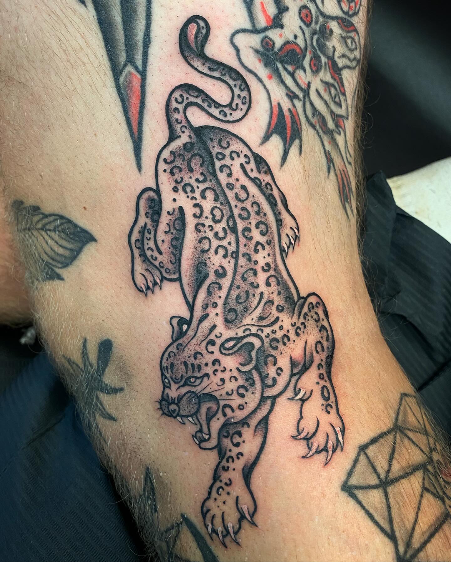 Leopard black and grey tattoo on the forearm by Jonah