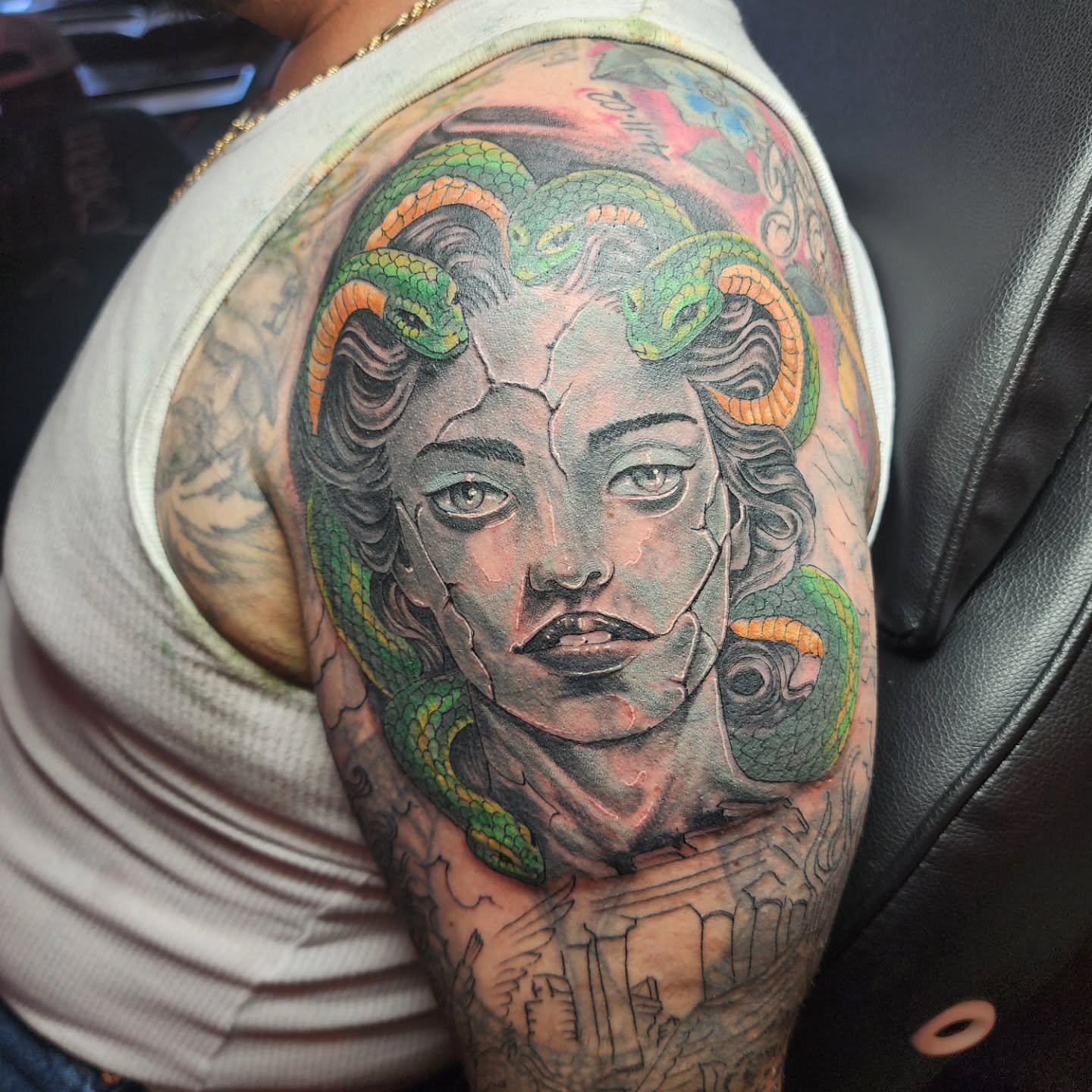 Woman with snakes realism tattoo on the shoulder by Joe Garcia
