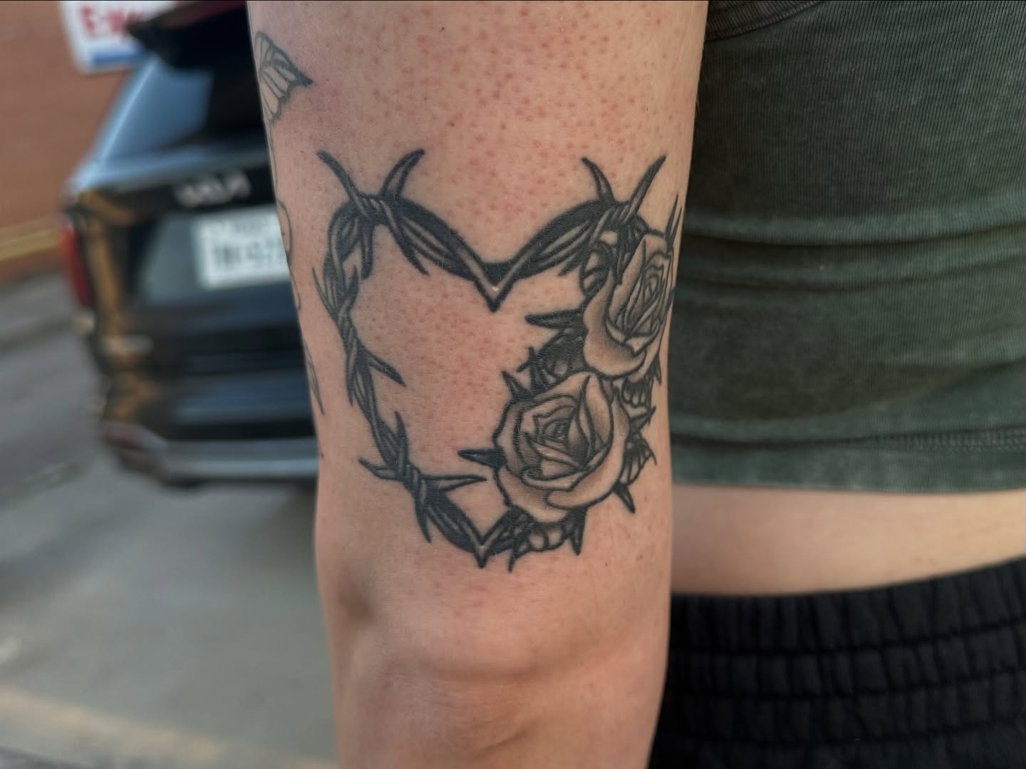 Barbed wire heart with roses black and grey tattoo on the forearm by Ash Nicole Painterly, San Diego, California
