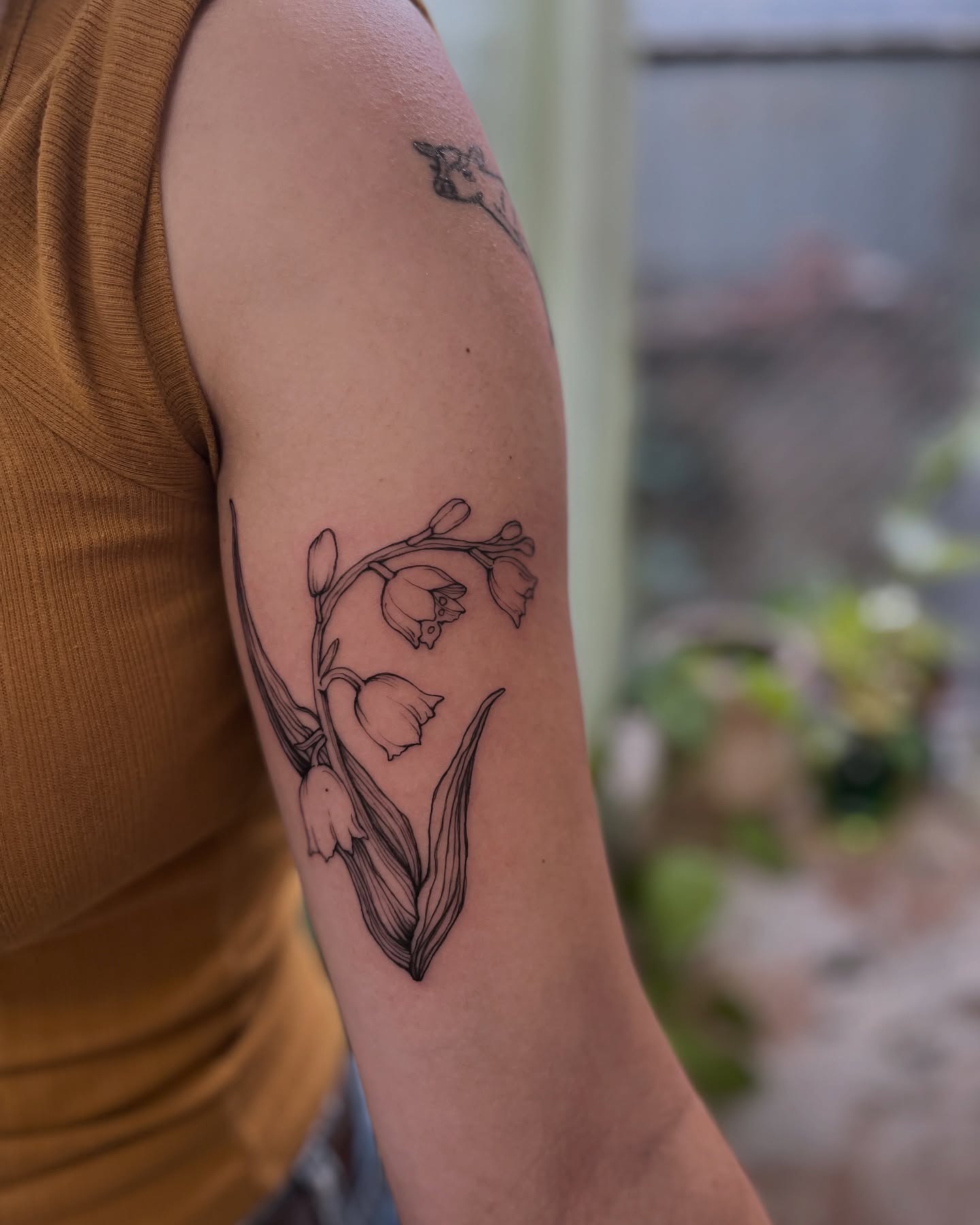 Lily of the valley fine line tattoo on the forearm by Ying Xeon