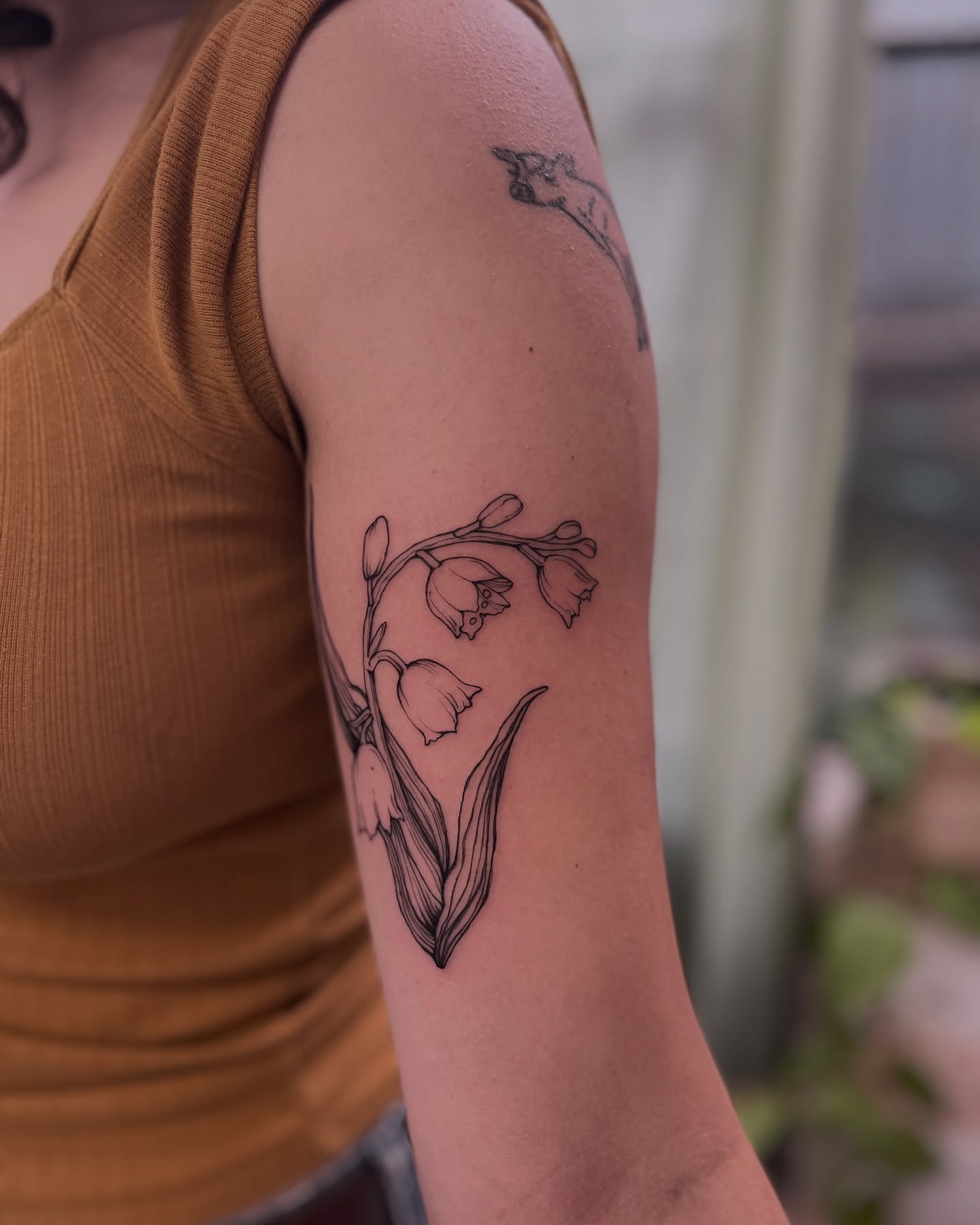 Lily of the valley fine line tattoo on the forearm by Ying Xeon