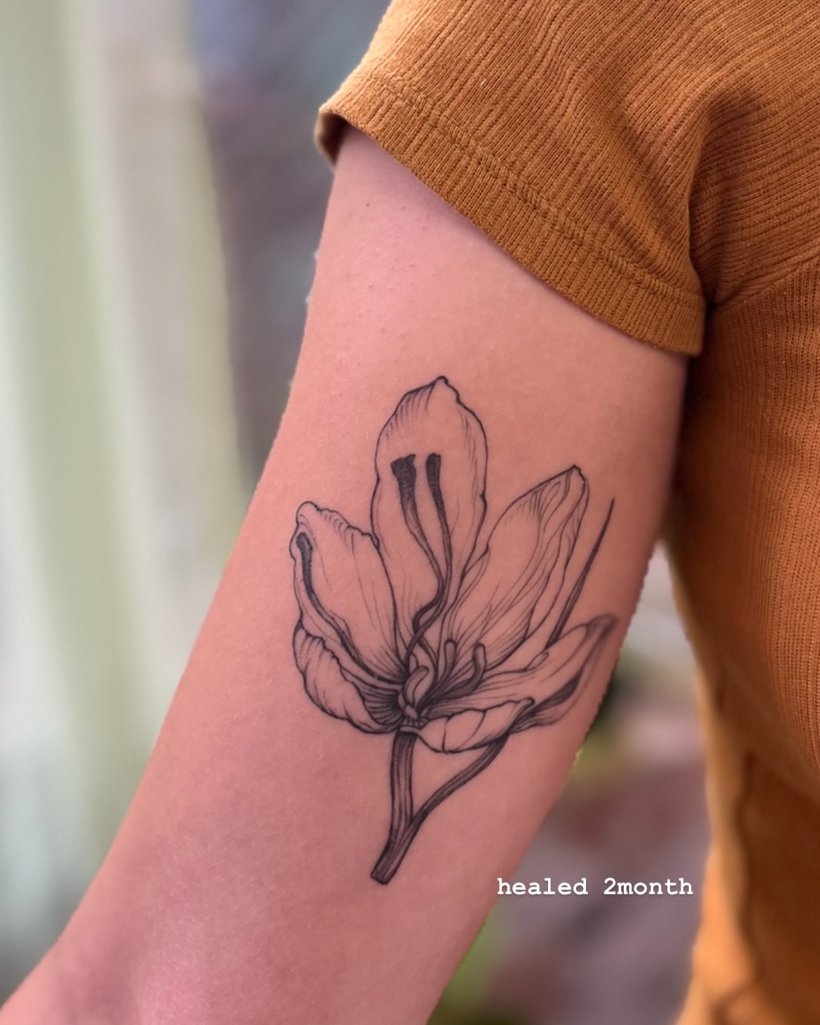 Magnolia flower black and grey tattoo on the forearm by Ying Xeon