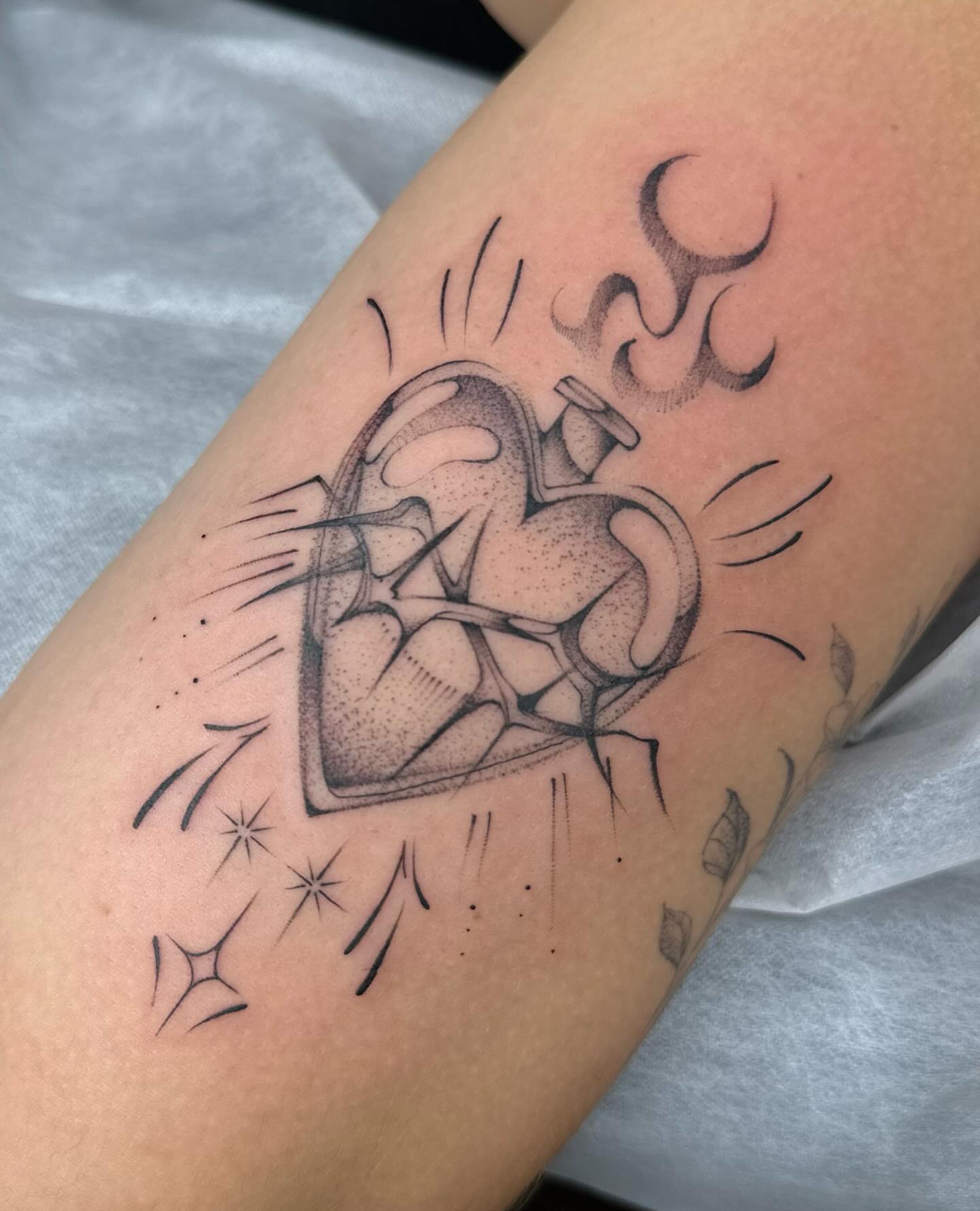 Heart with wings dotwork tattoo on the forearm by Maggie Angulo