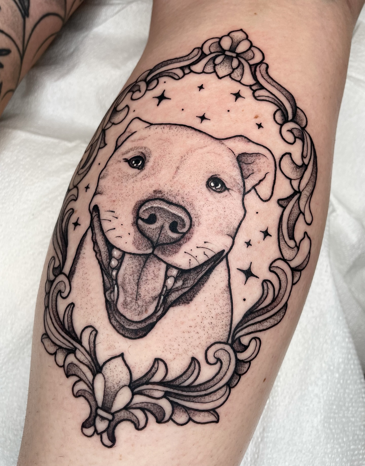 Pit bull dotwork tattoo on the thigh by Emily Lux