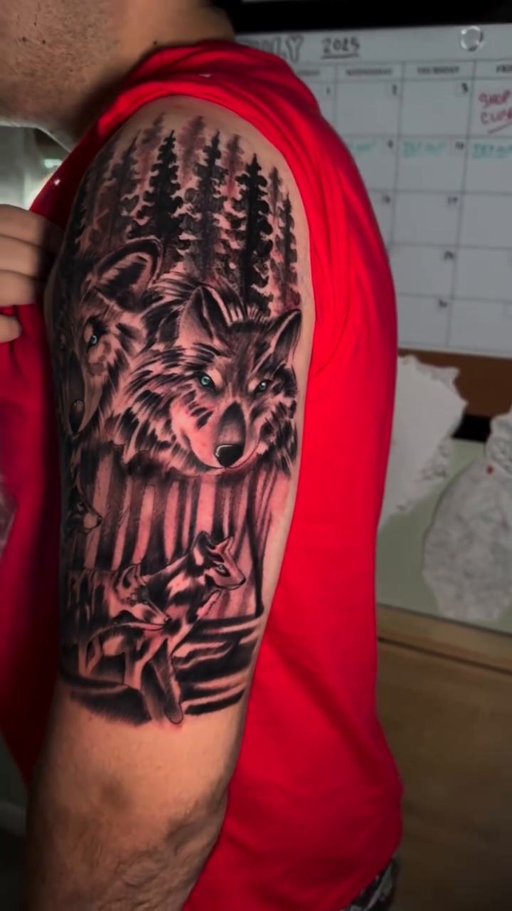 Wolves in a forest realism tattoo on the upper arm by Dustin Schild, Memphis, Tennessee