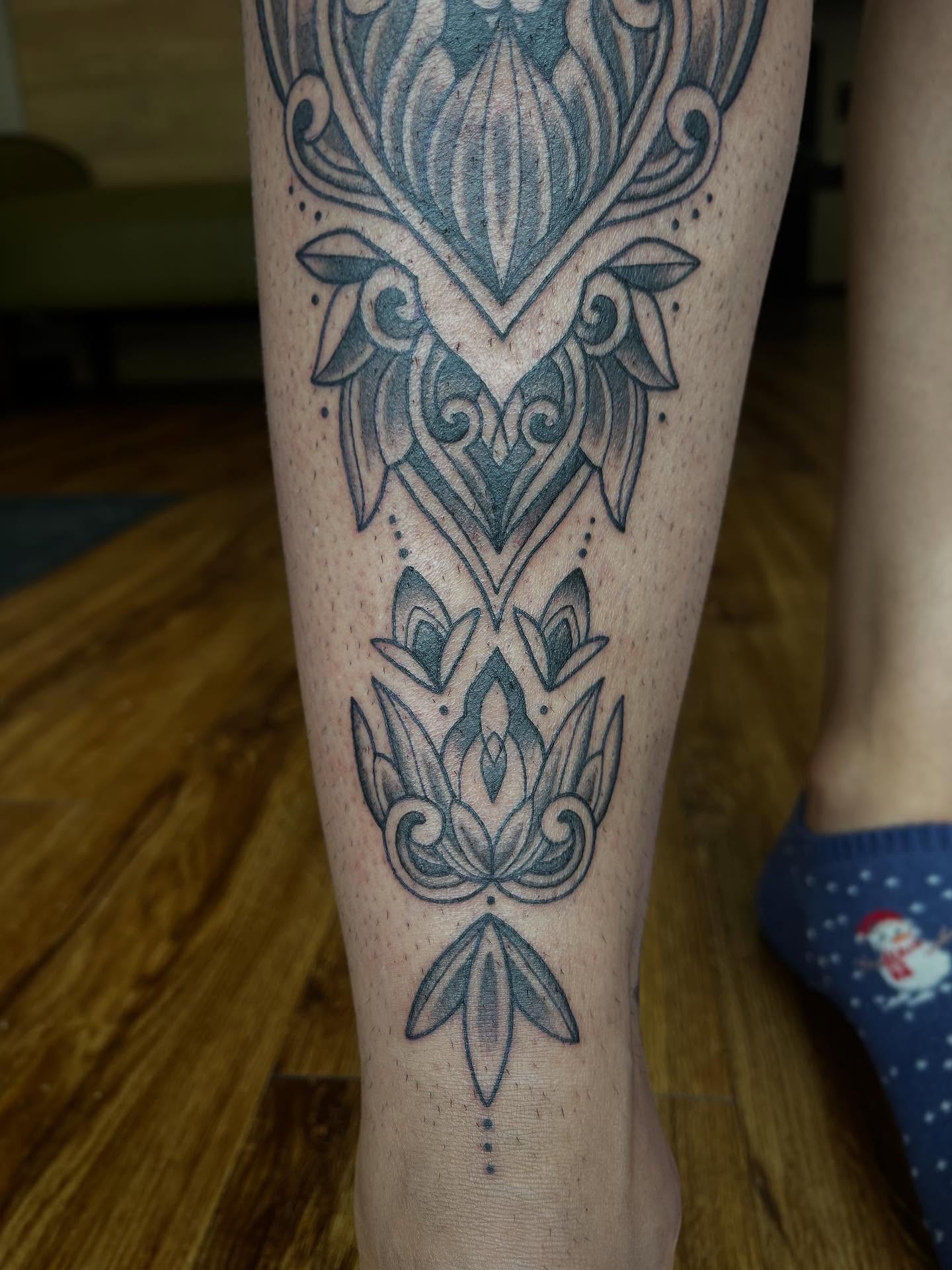Lotus flower ornamental tattoo on the calf by Taylor Santavicca
