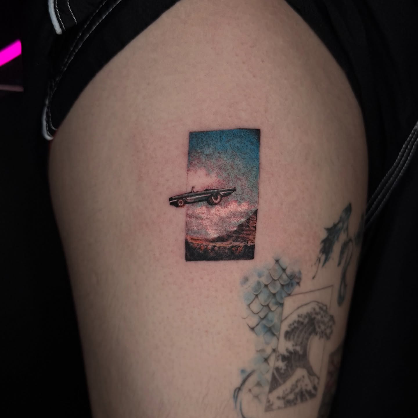 Car in landscape realism tattoo on the thigh by B o n d B o n d , “ a r t i s t “