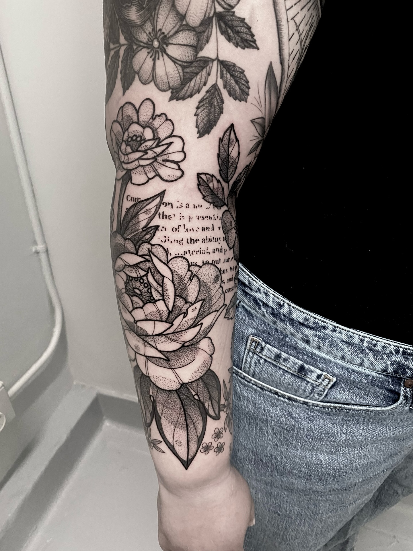 Floral bouquet black and grey tattoo on the forearm by Rowan Starr
