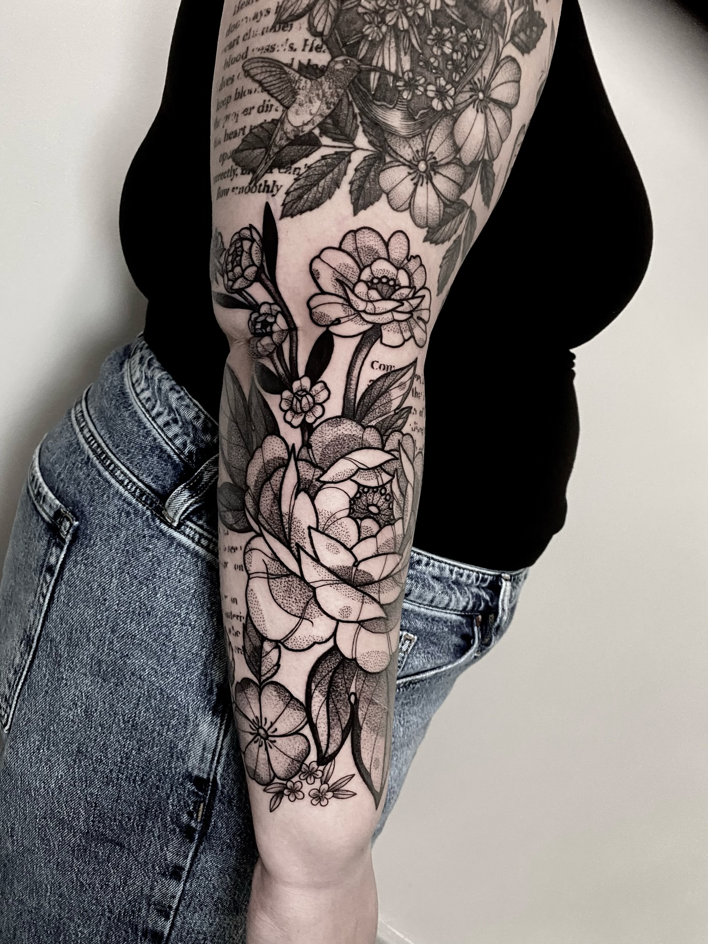 Floral arrangement realism tattoo on the forearm by Rowan Starr