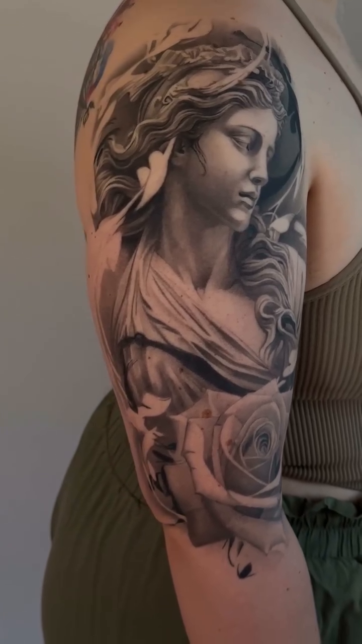 Statue of a woman with roses realism tattoo by Paige Jean
