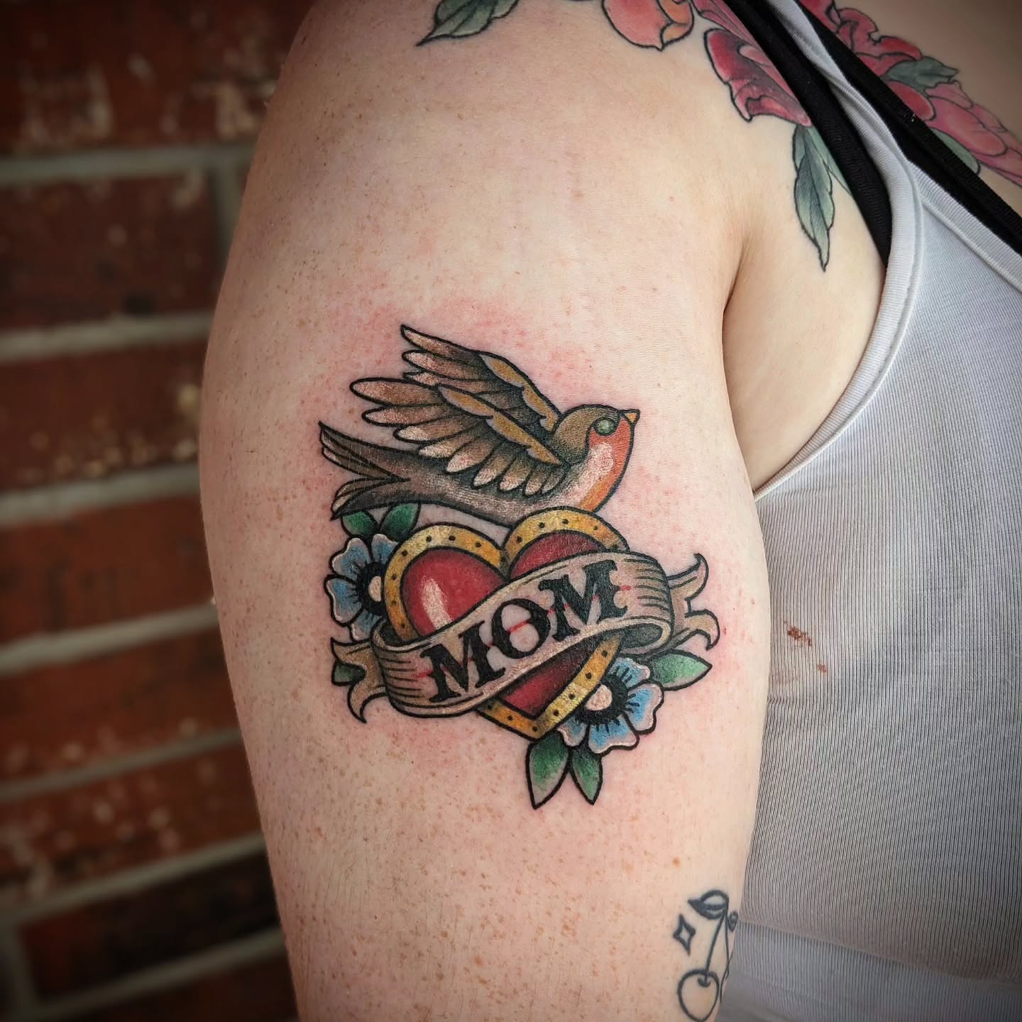 Bird and heart American traditional tattoo on the shoulder by 𝕸𝖆𝖉𝖎 (𝕸𝖆𝖉 𝕯𝖔𝖌)