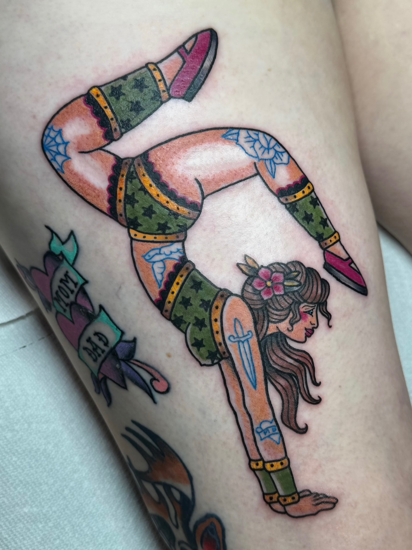 Female acrobat American traditional tattoo on the thigh by Ashley Laine Evans