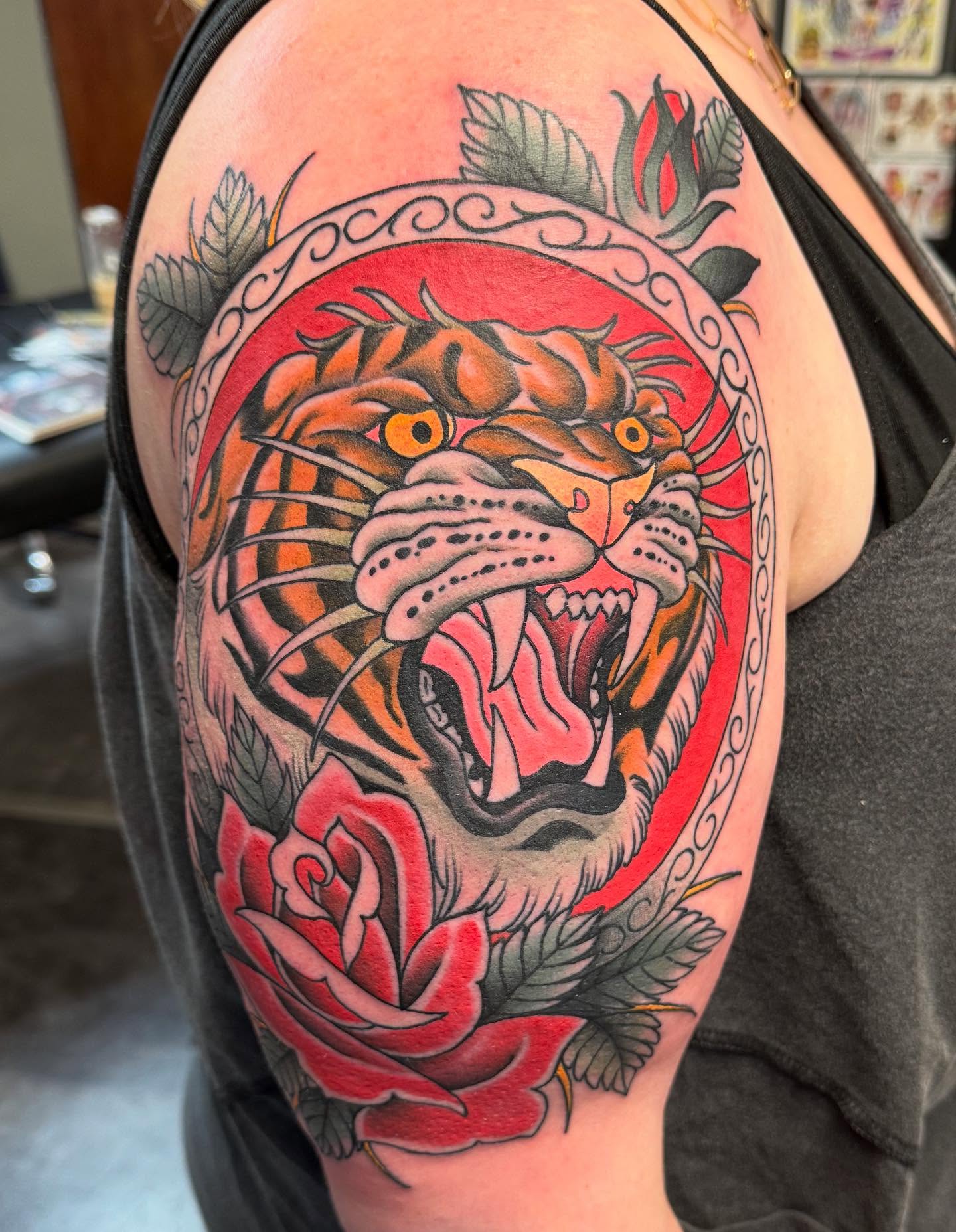 Roaring tiger American traditional tattoo on the shoulder by Jason Lawyer