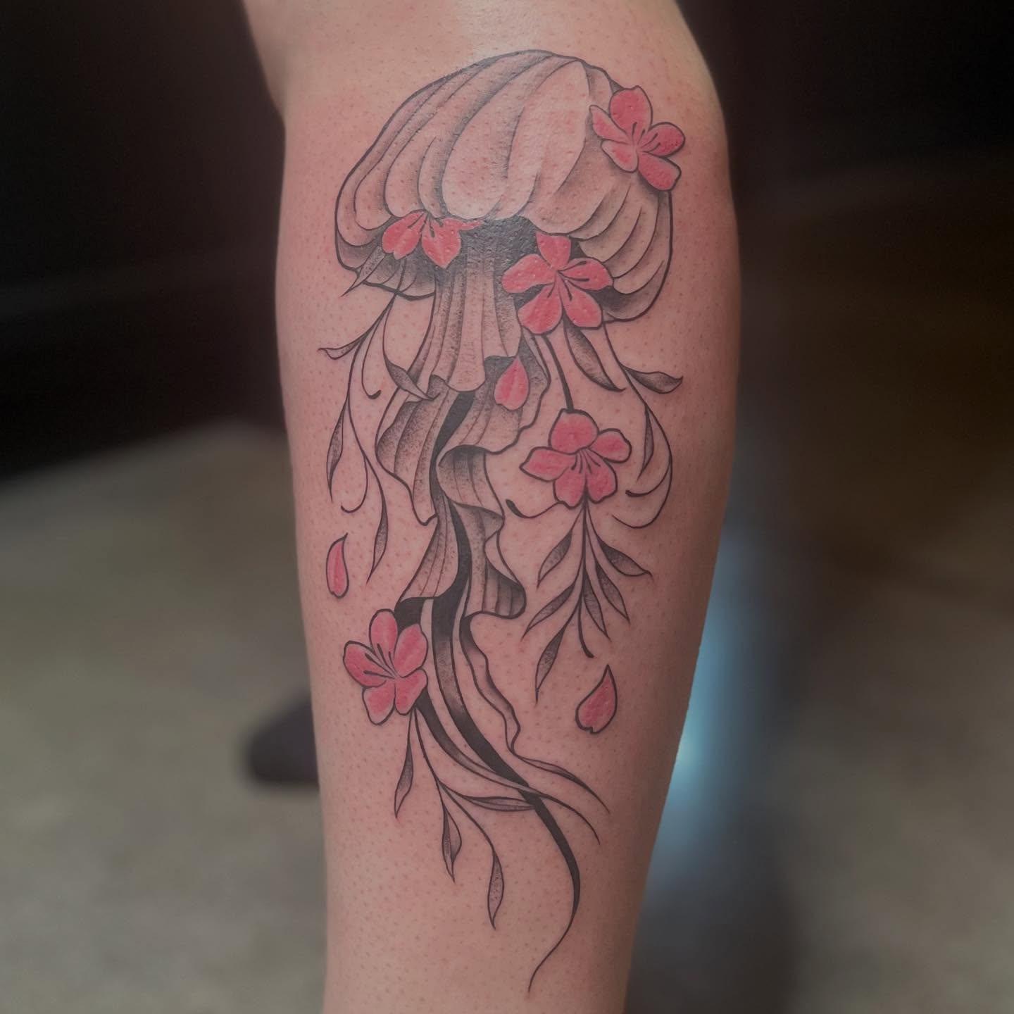 Jellyfish and flowers dotwork tattoo on the thigh by Lexi Ross