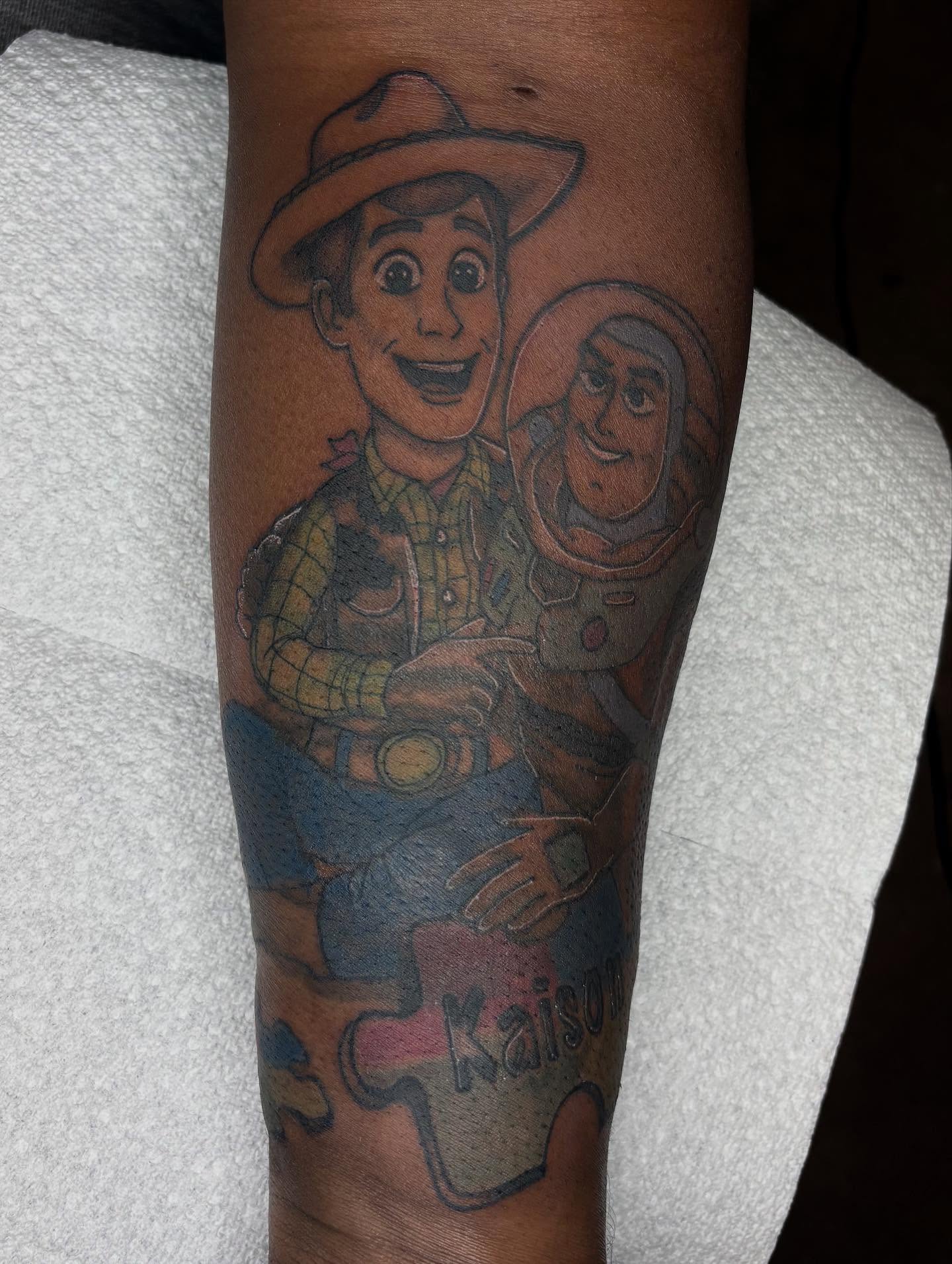 Toy Story characters realism tattoo on the forearm by Evan Chastain