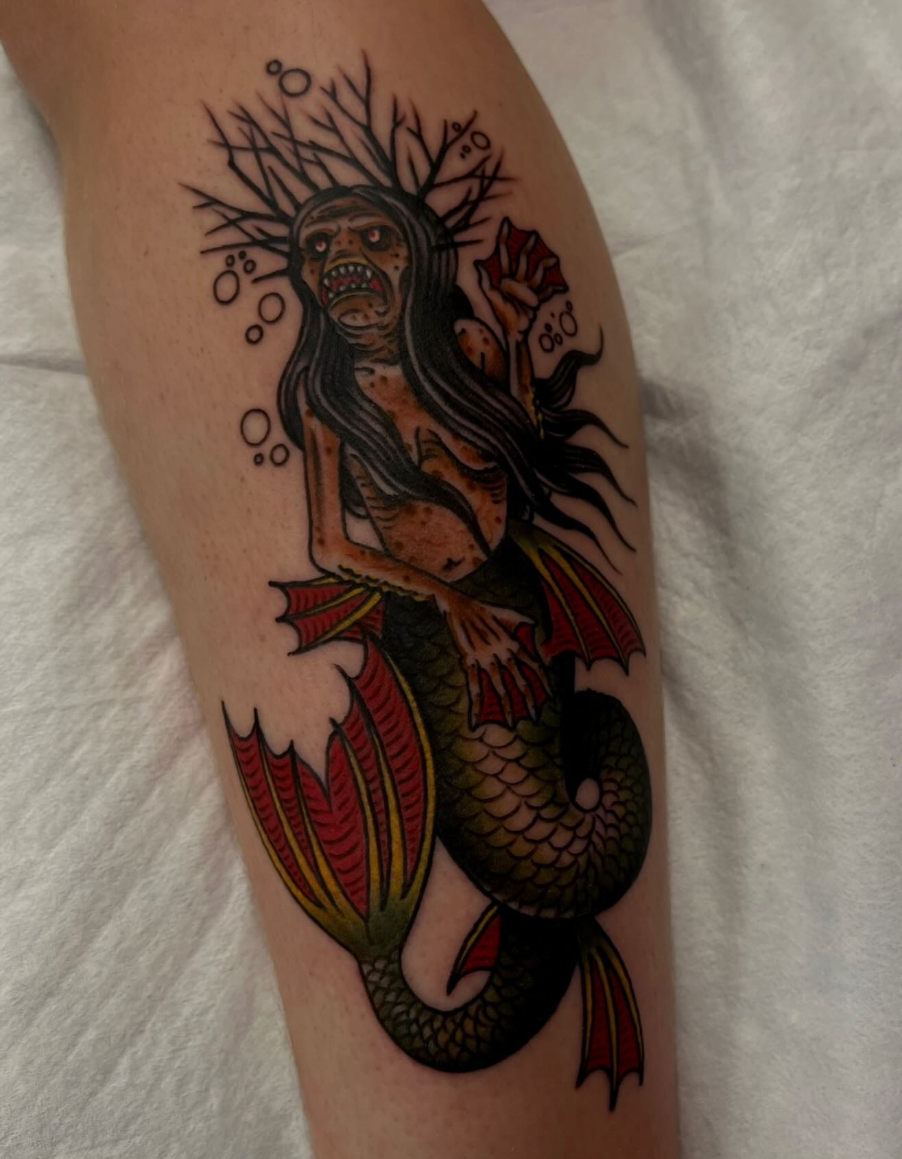 Mermaid American traditional tattoo on the thigh by Lee Brewster, Erlanger, Kentucky