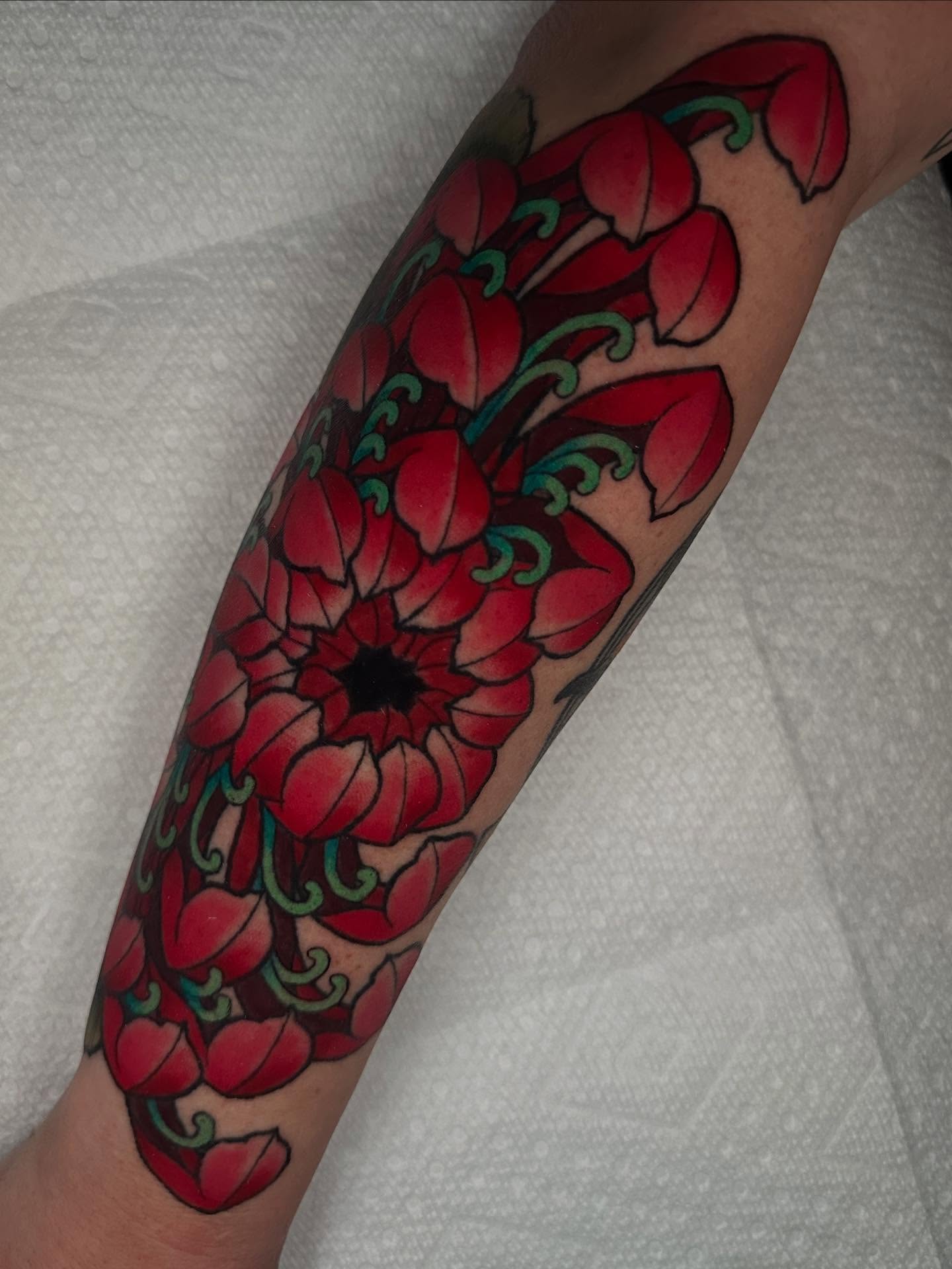 Red poppies American traditional tattoo on the forearm by Lexi Wilkinson