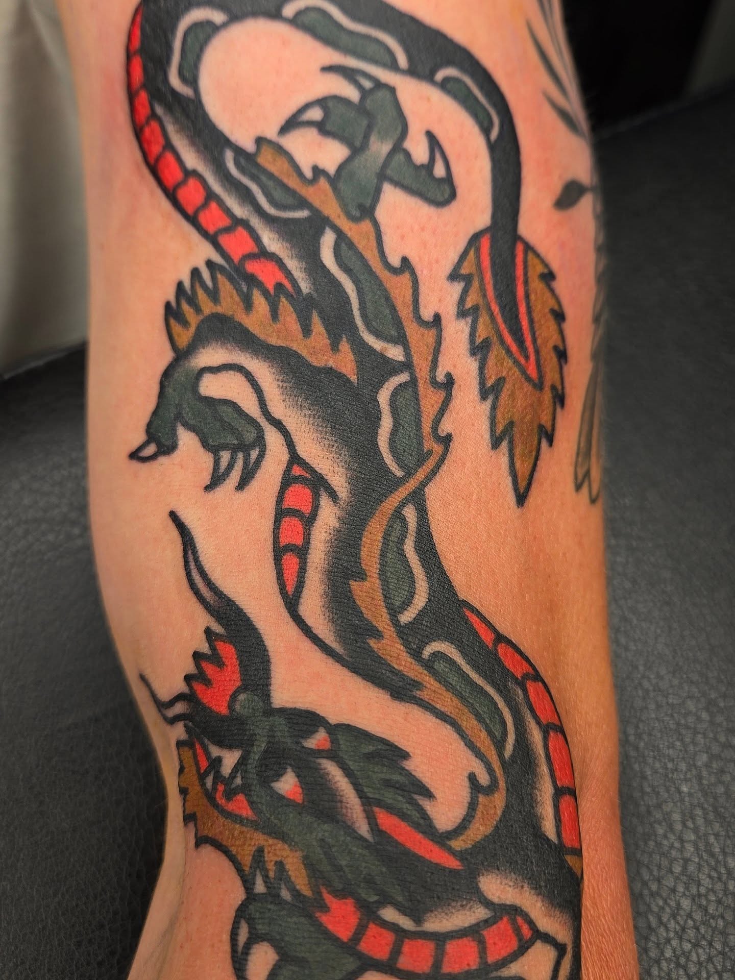 Dragon American traditional tattoo on the forearm by Deke Harms, Bend, Oregon