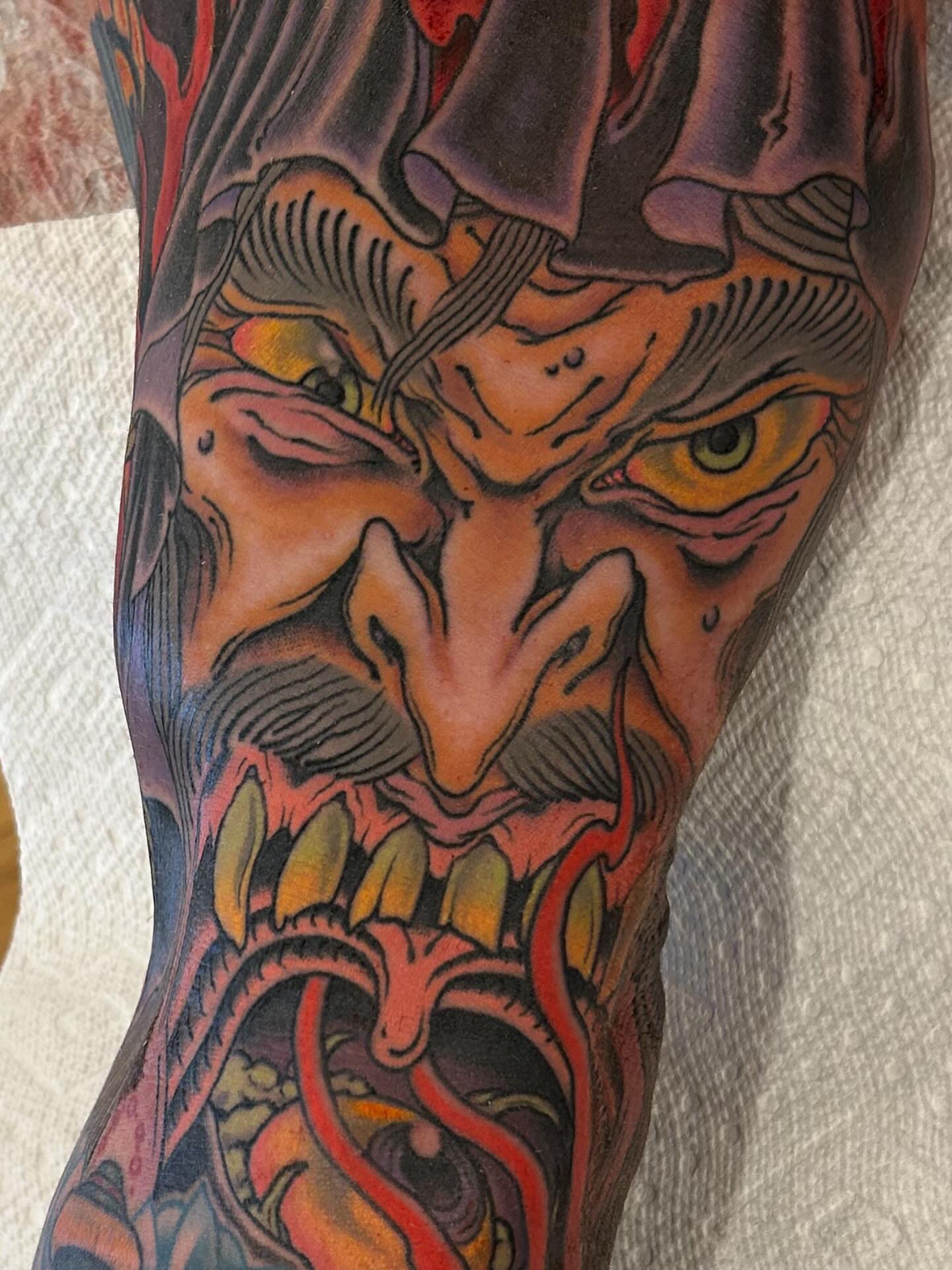 Demon face dark realism tattoo on the forearm by Craig Gardyan
