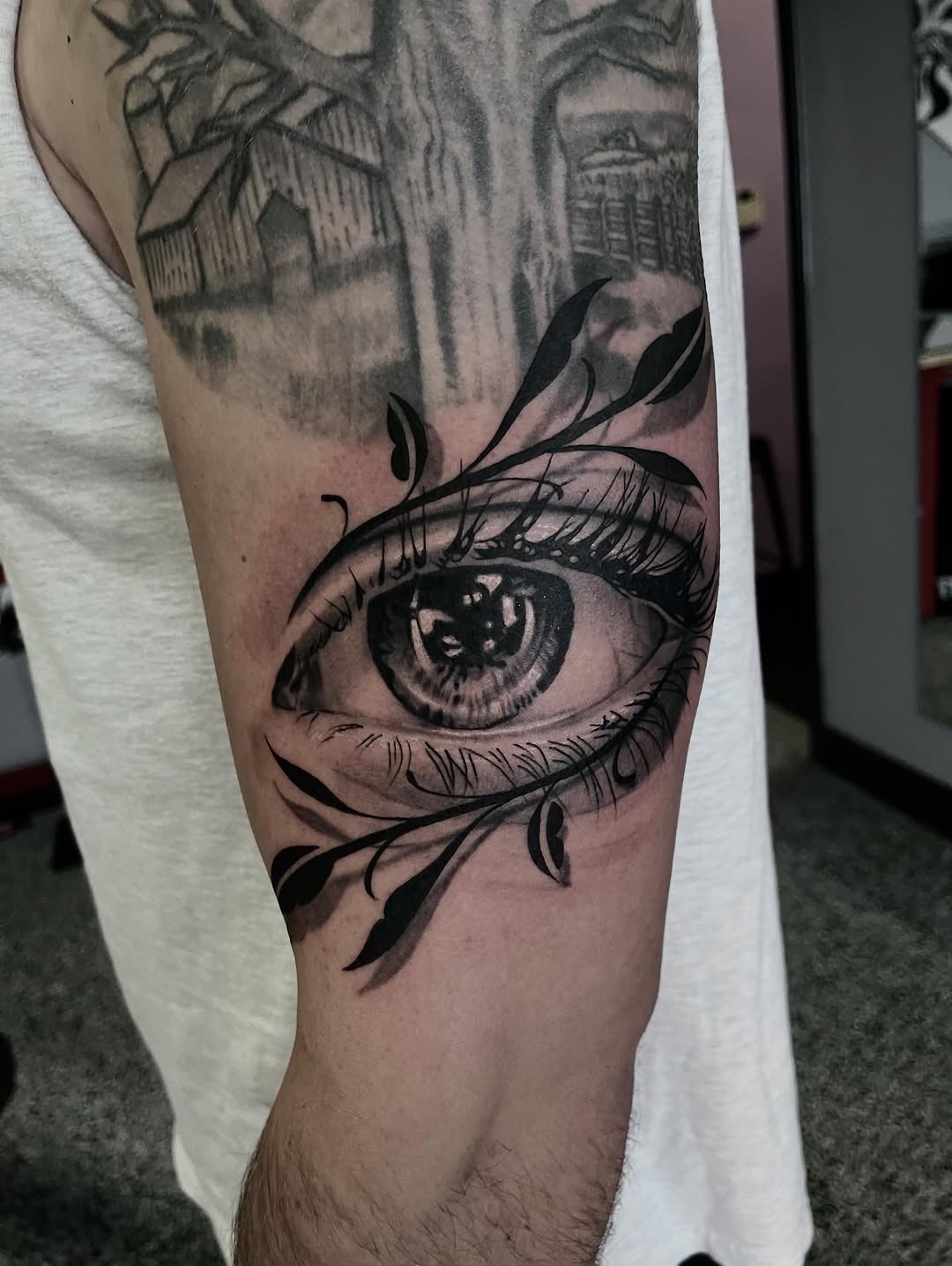 Eye with vine surrealism tattoo on the forearm by Jonathan Red