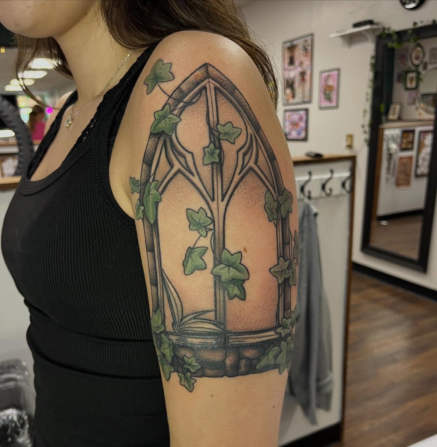 Gothic window with ivy realism tattoo on the shoulder by Lauren Bumgardner
