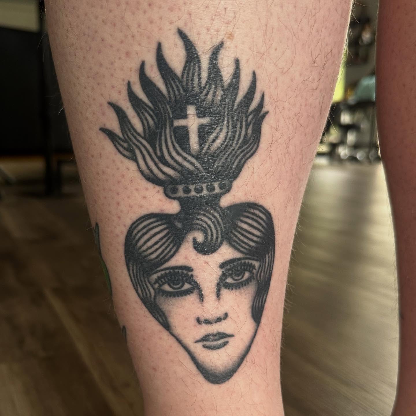 Flame-topped heart black and grey tattoo on the forearm by Jess Ritchie, Austin, Texas