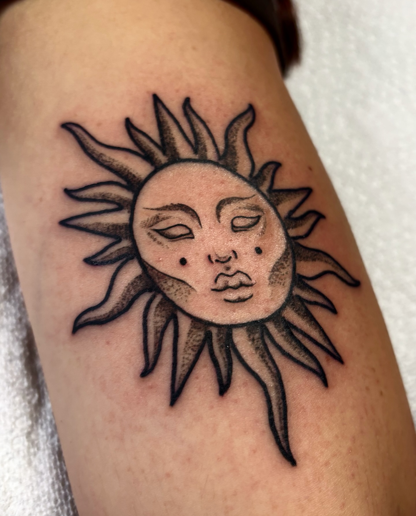 Sun face black and grey tattoo on the forearm by Nashville Tattoo Artist