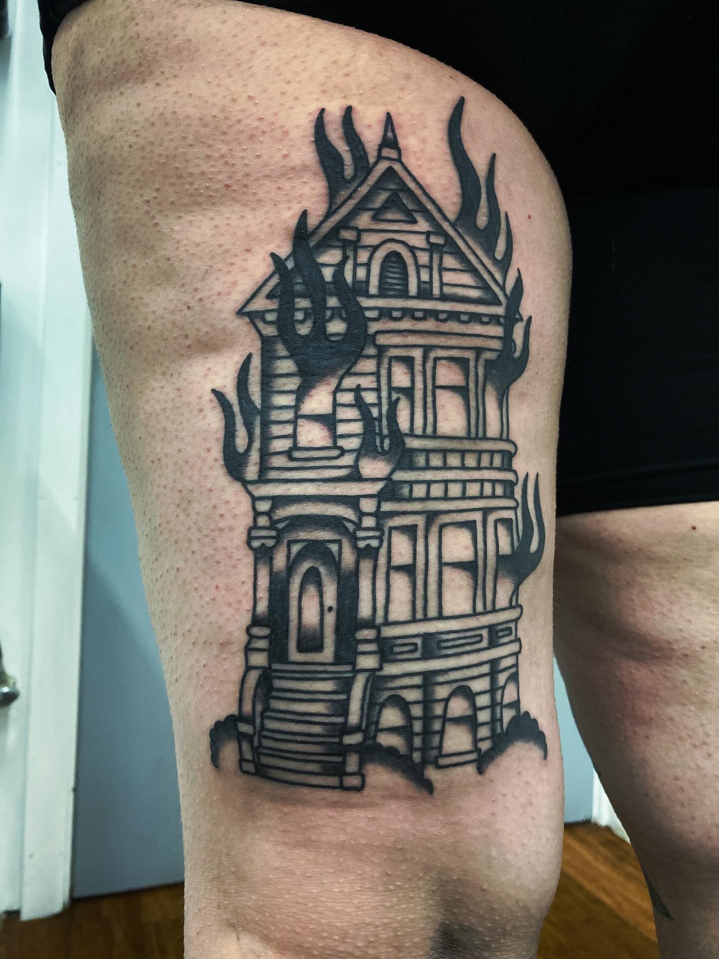 Haunted house black and grey tattoo on the thigh by @rubber_band_dan, San Francisco, California