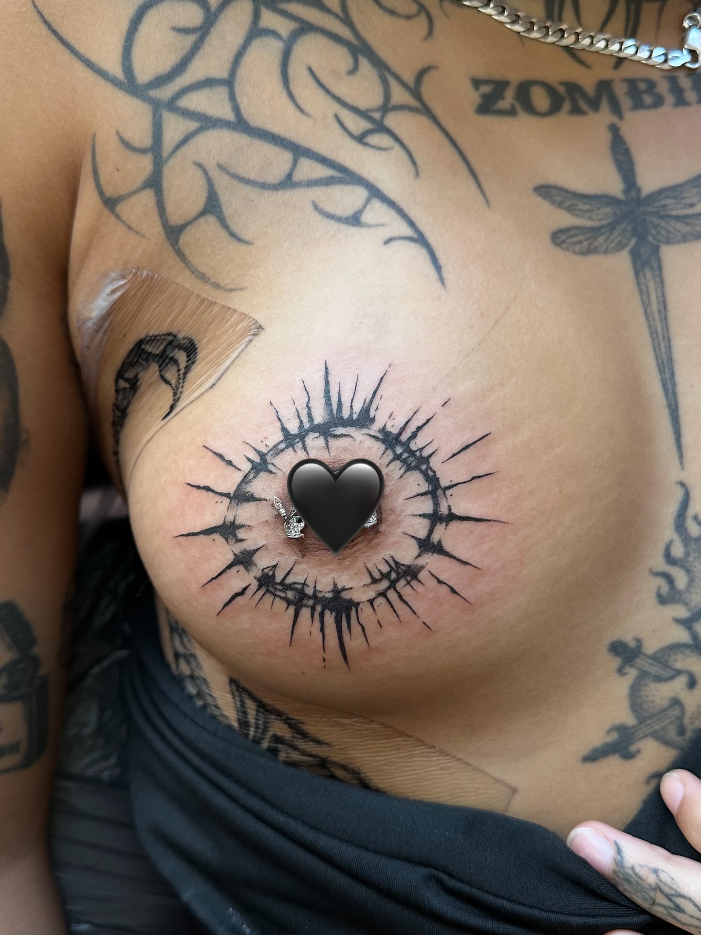 Eye with heart black and grey tattoo on the chest by Casper Tattoos Toronto