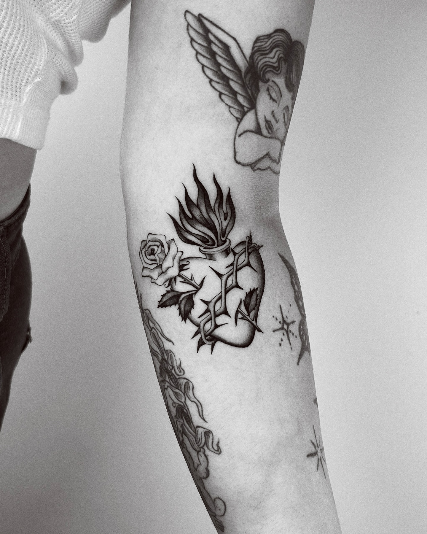 Angel and demon American traditional tattoo on the forearm by Montana Chambers