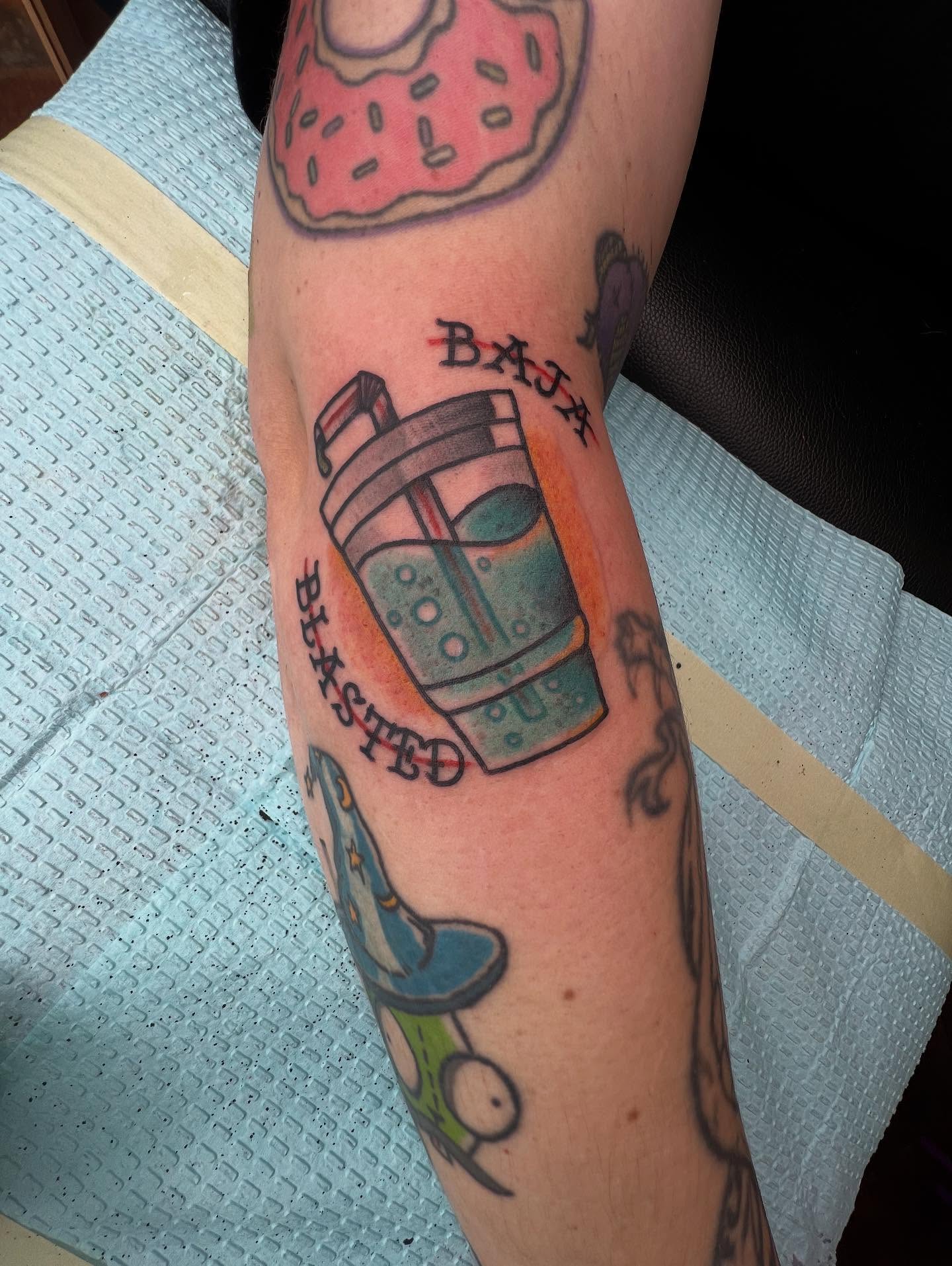 Donut and coffee cup American traditional tattoo on the forearm by Mika Clairissa