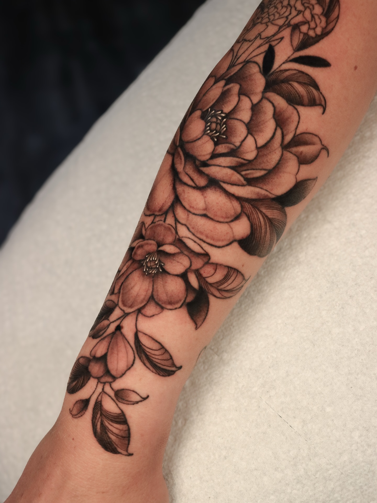 Peony flowers black and grey tattoo on the forearm by Jeff Reindel
