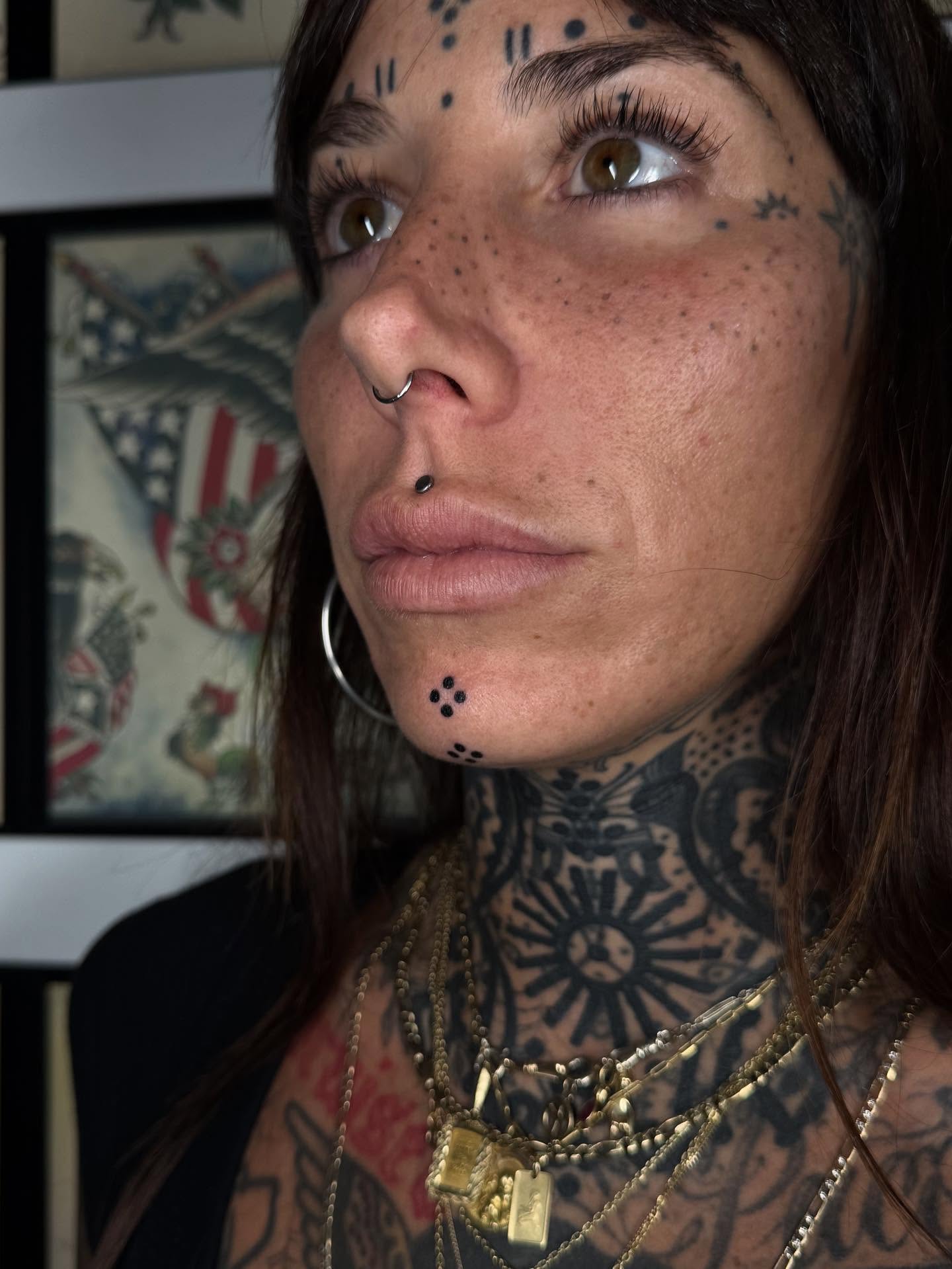 Face and neck dotwork tattoo on the neck by Erin Shea