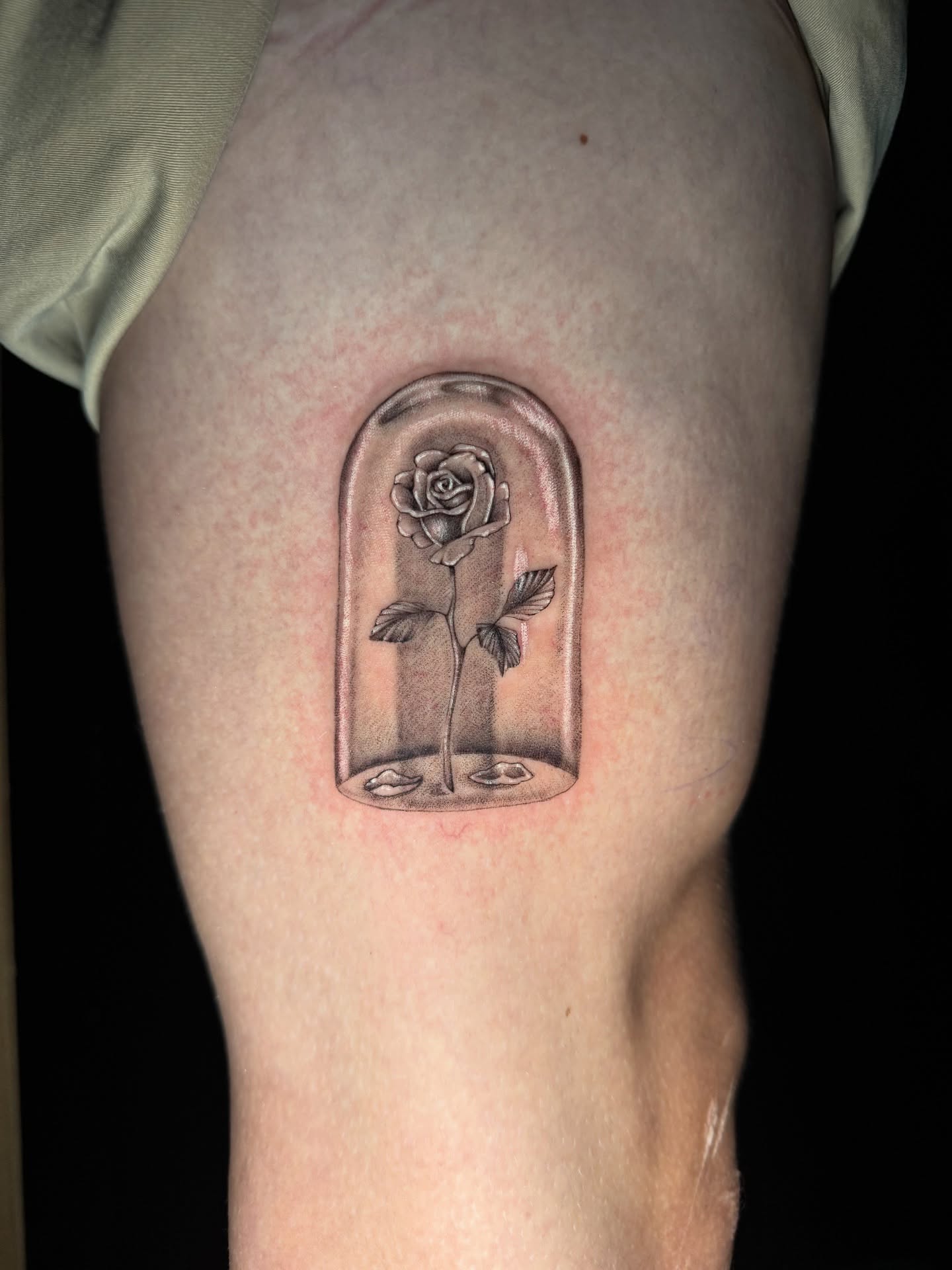 Rose in bell jar black and grey tattoo on the thigh by 𝕸𝖔𝖓𝖎𝖖𝖚𝖊𝖊𝖓
