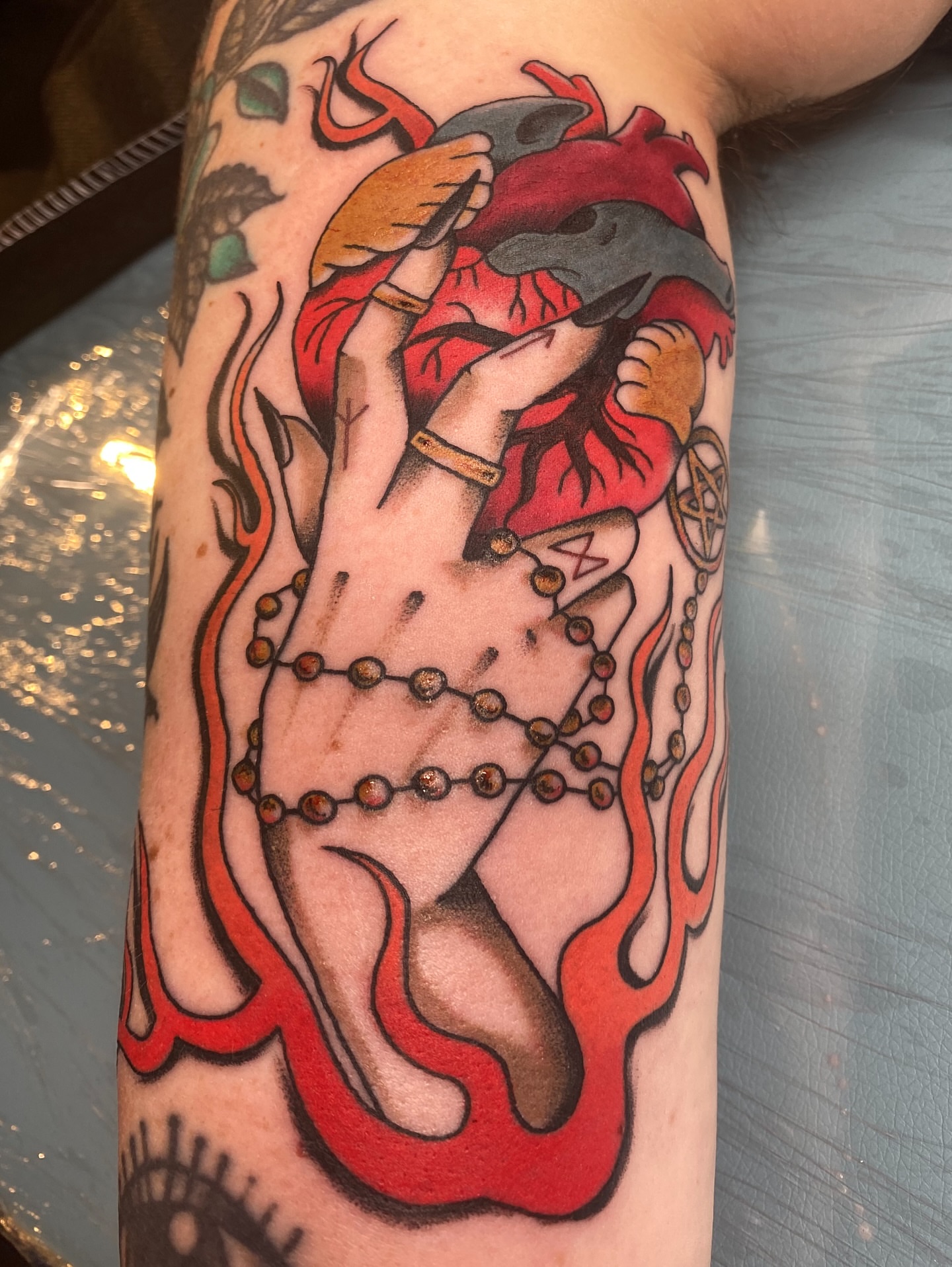 Heart with hands American traditional tattoo on the forearm by Sophie McTear