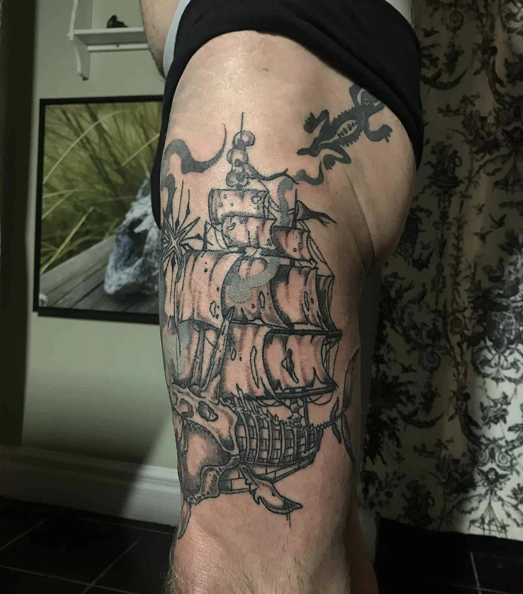 Ship black and grey tattoo on the thigh by Kim