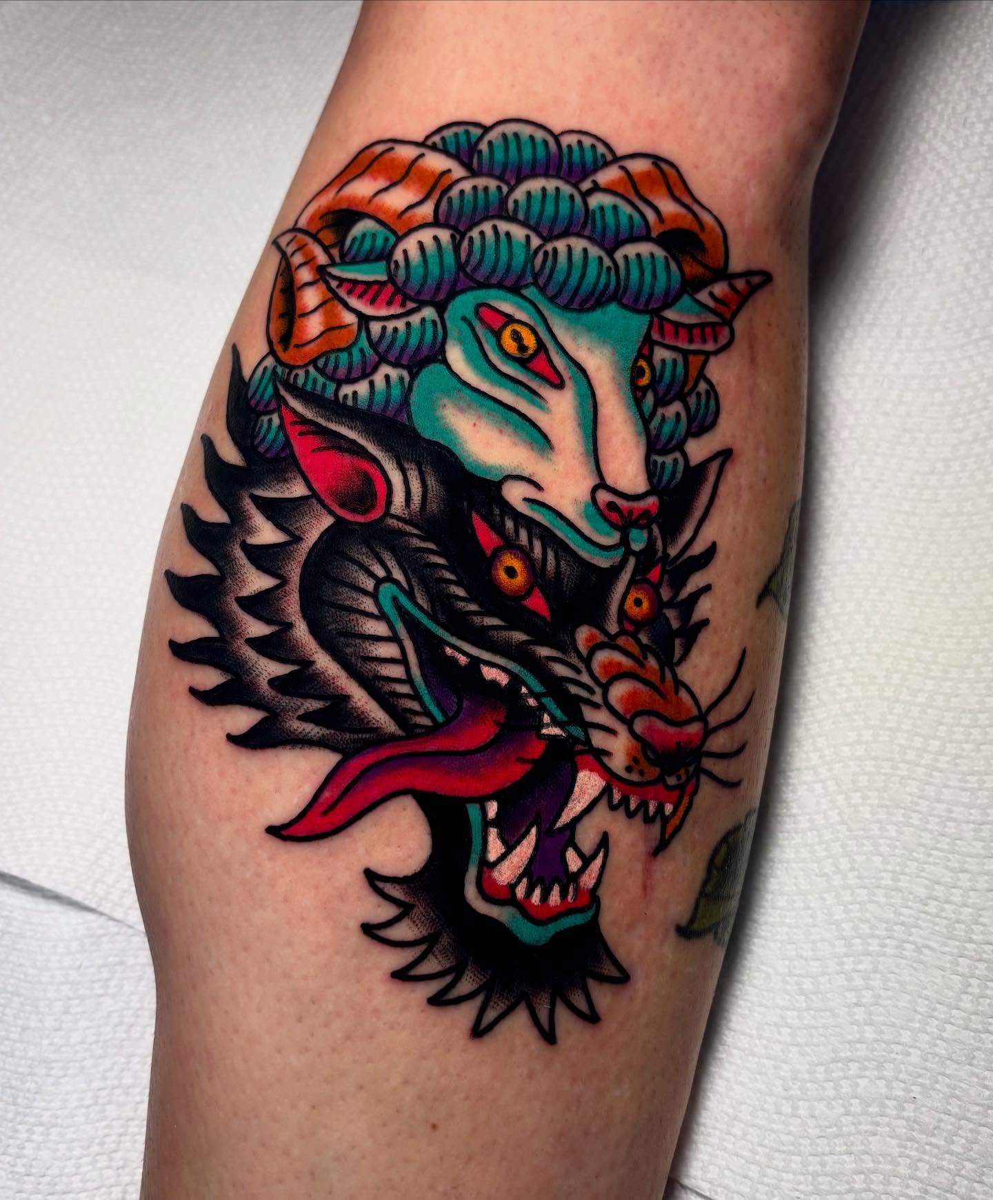 Lion and ram American traditional tattoo on the forearm by Mickey Putillo, Charlotte, North Carolina
