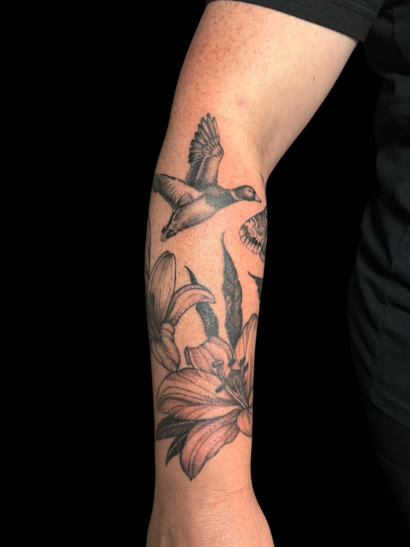 Geese and flowers black and grey tattoo on the forearm by Brennan Walker, Orem, Utah