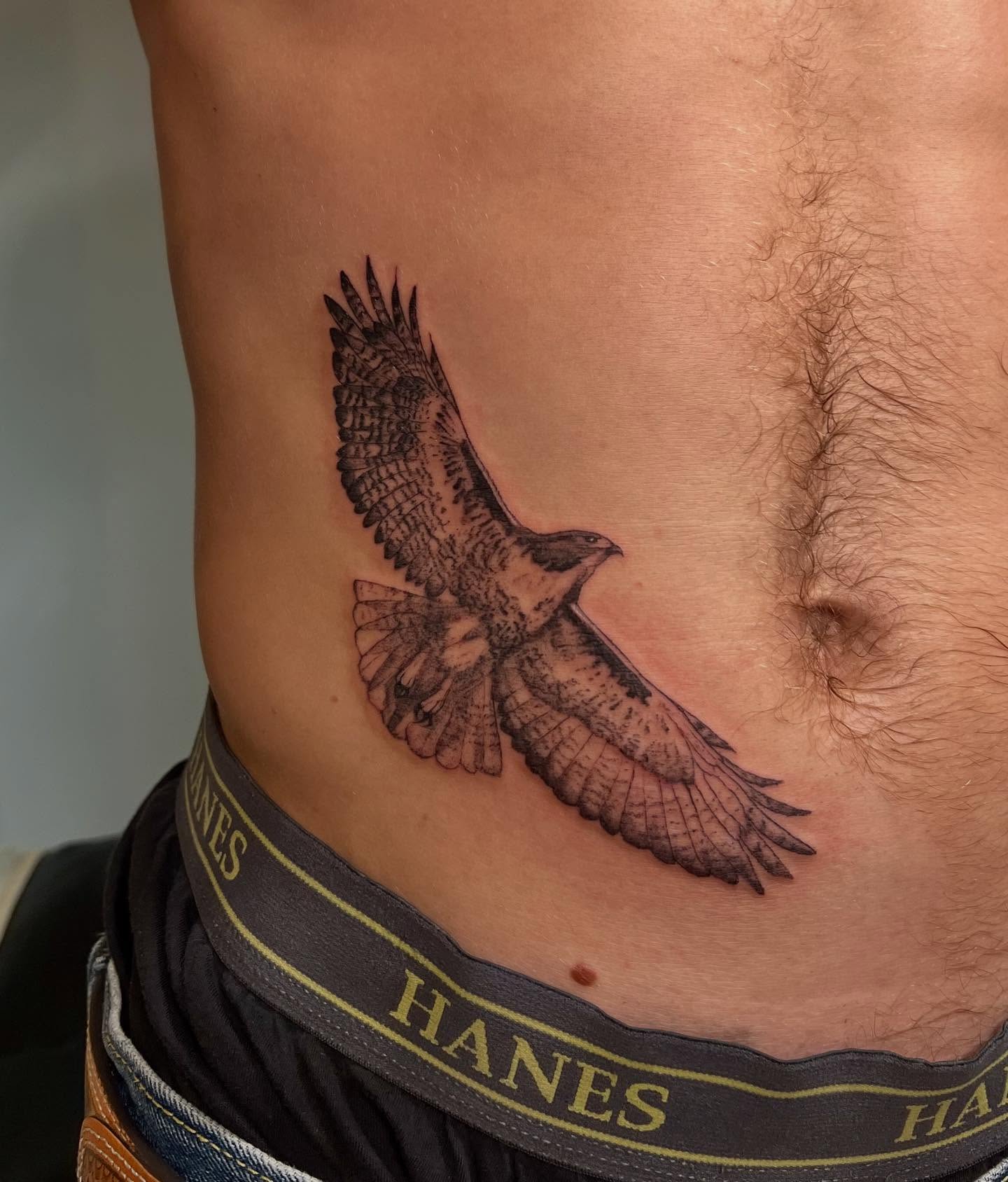 Hawk realism tattoo on the ribs by sarah bug