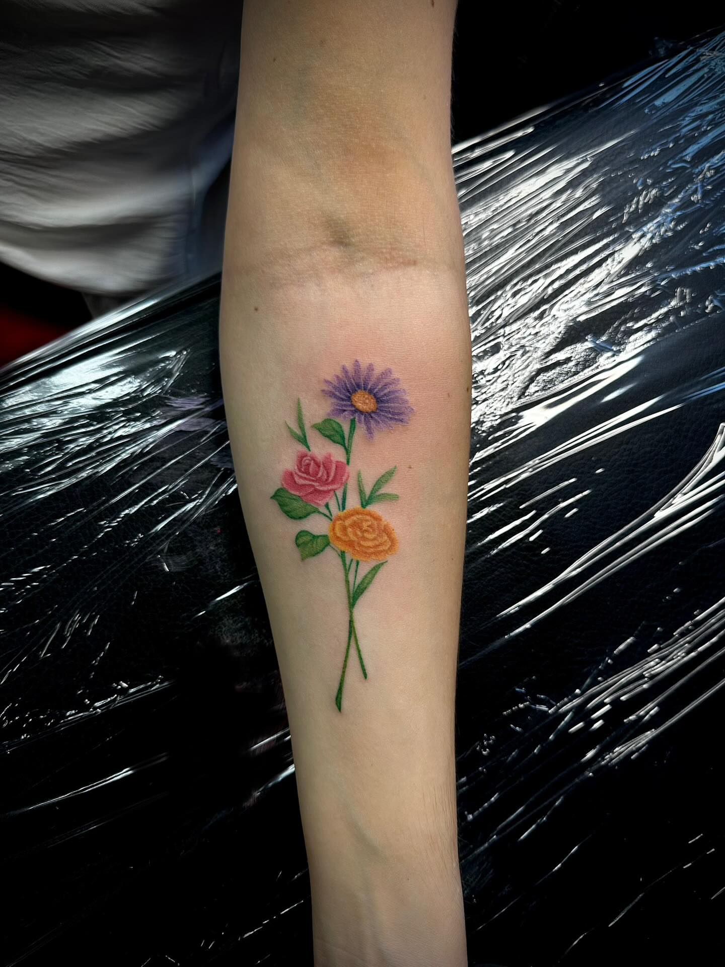 Flowers dotwork tattoo on the forearm by Madison Orchard Tattoos