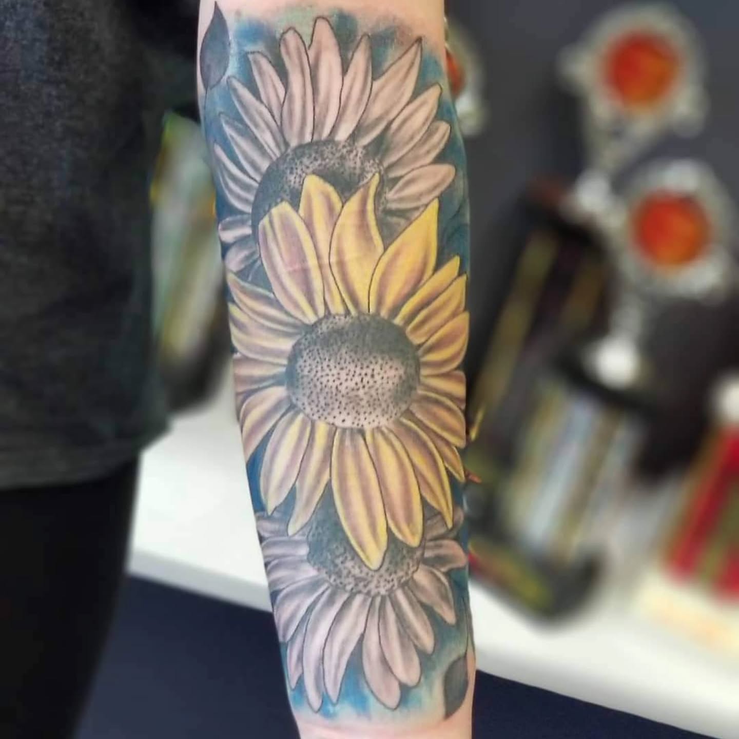 Sunflowers American traditional tattoo on the forearm by Dennis Foust