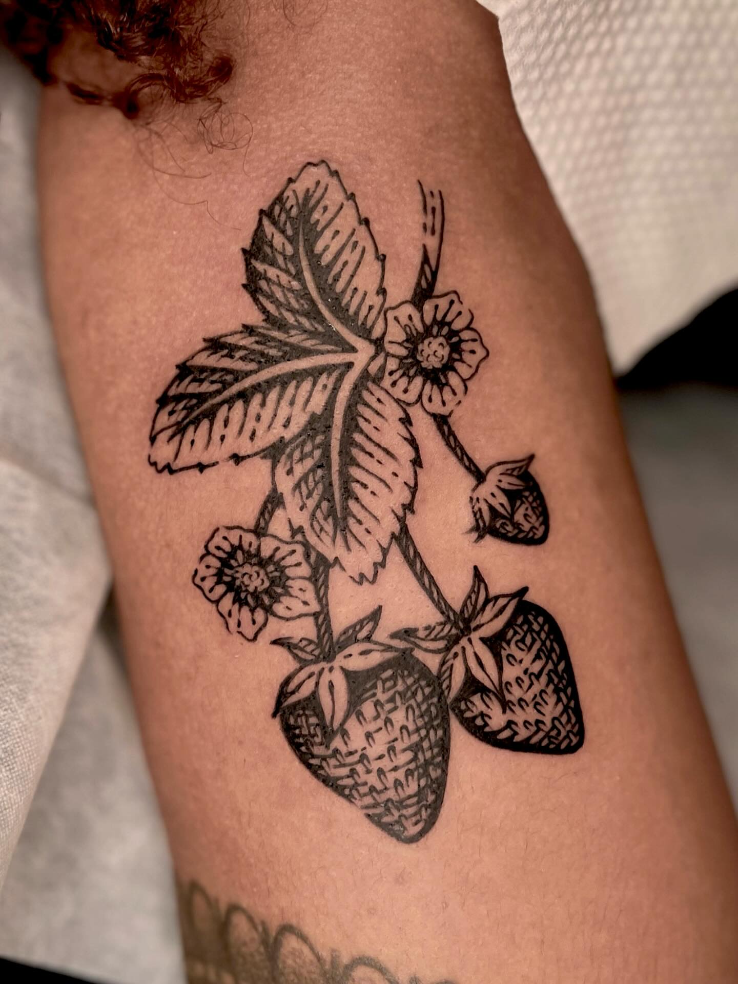 Strawberry plant black and grey tattoo on the thigh by Wonny